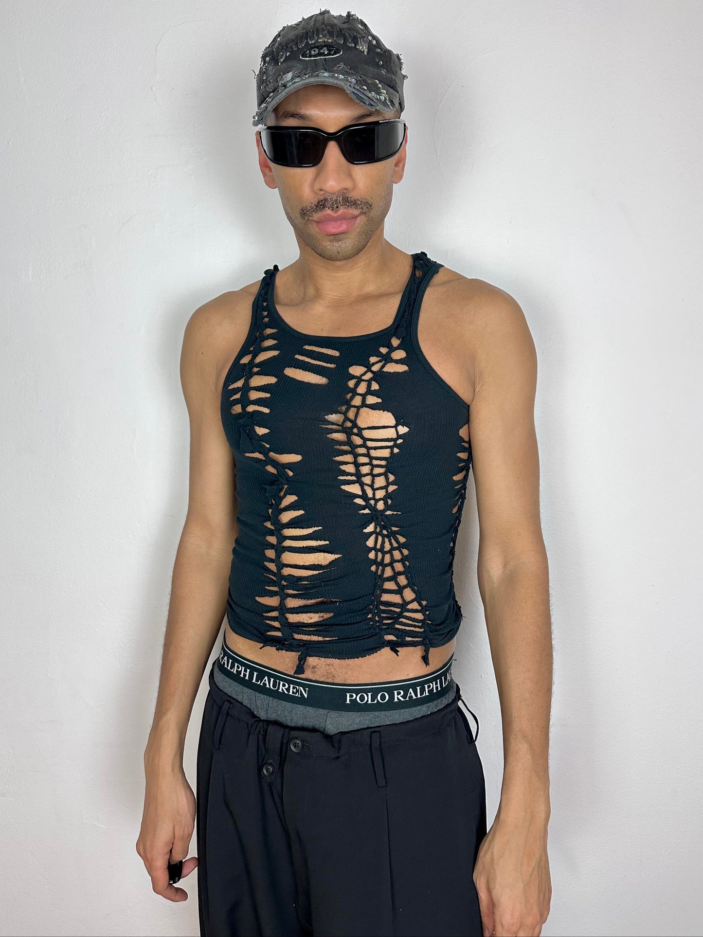 Male model wearing ASTROBOI* x Gildan 'Magnus' black braided twist tank top, styled full look, ASTROBOI* STUDIO NYC.