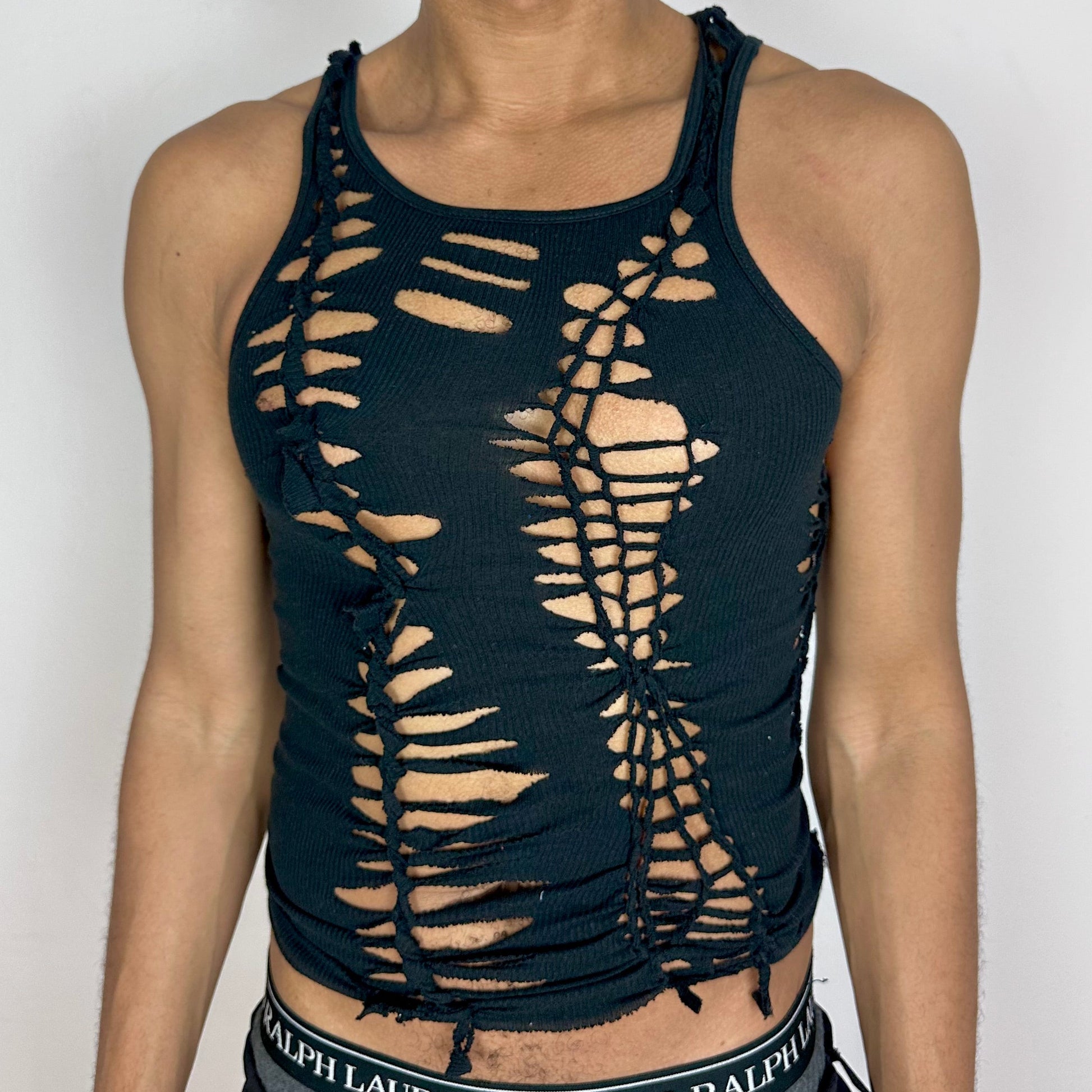 Close-up of ASTROBOI* x Gildan 'Magnus' showing hand-braided construction and cut-out detailing on black 100% cotton fabric.