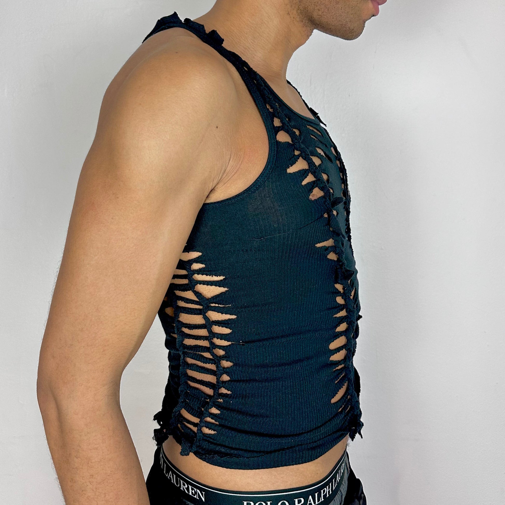 Right side detail of ASTROBOI* x Gildan 'Magnus' showing braided twist and cut-out construction on slim-fitting black cotton base.