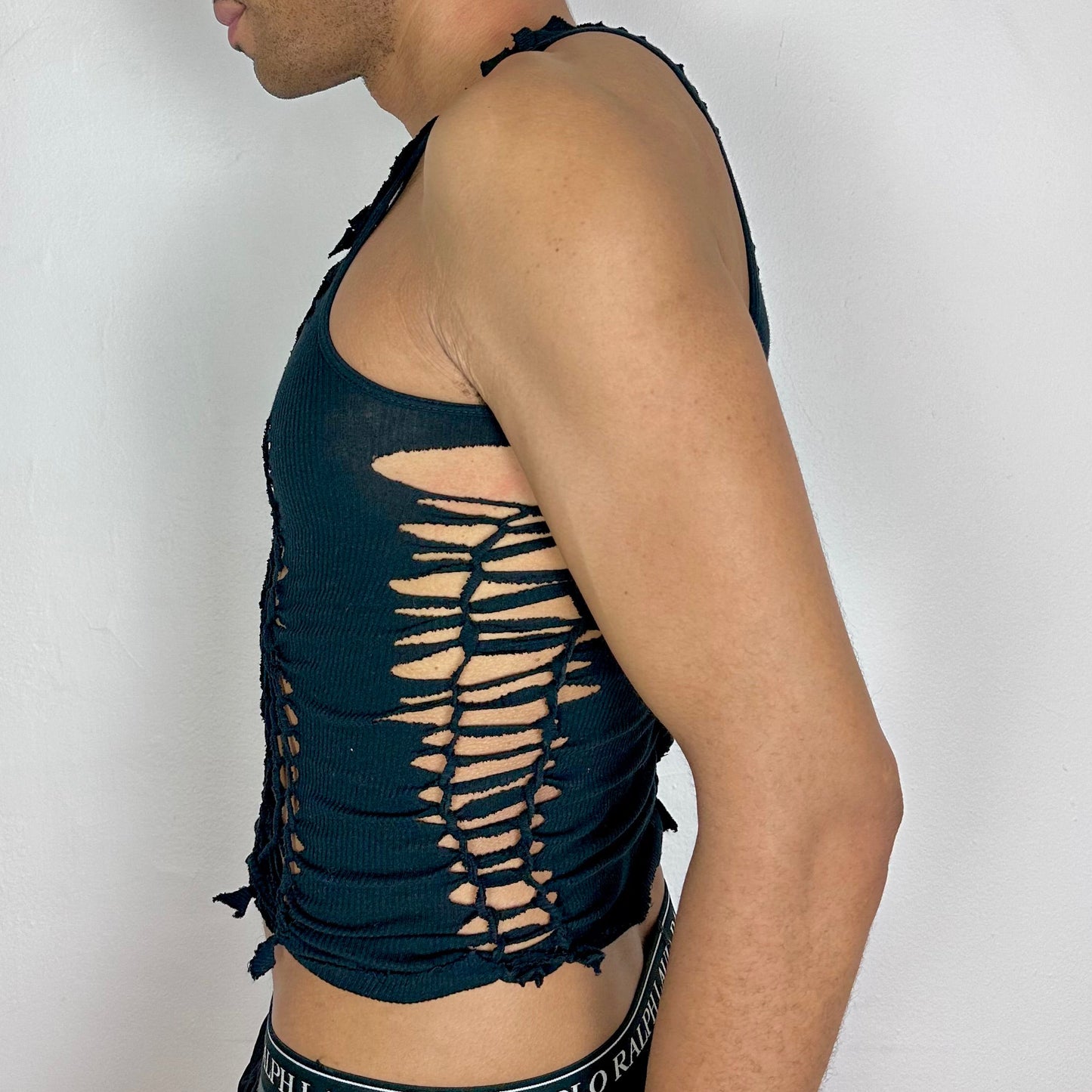 Left side detail of ASTROBOI* x Gildan 'Magnus' showing hand-braided arrangement and cut-out detailing on cropped black tank.
