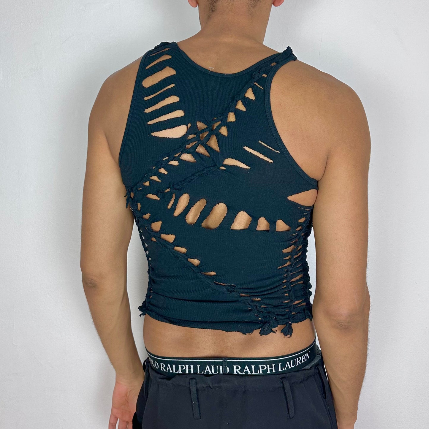 ASTROBOI* x Gildan 'Magnus' black braided twist tank top, rear view showing braid and cut-out construction, worn by male model.