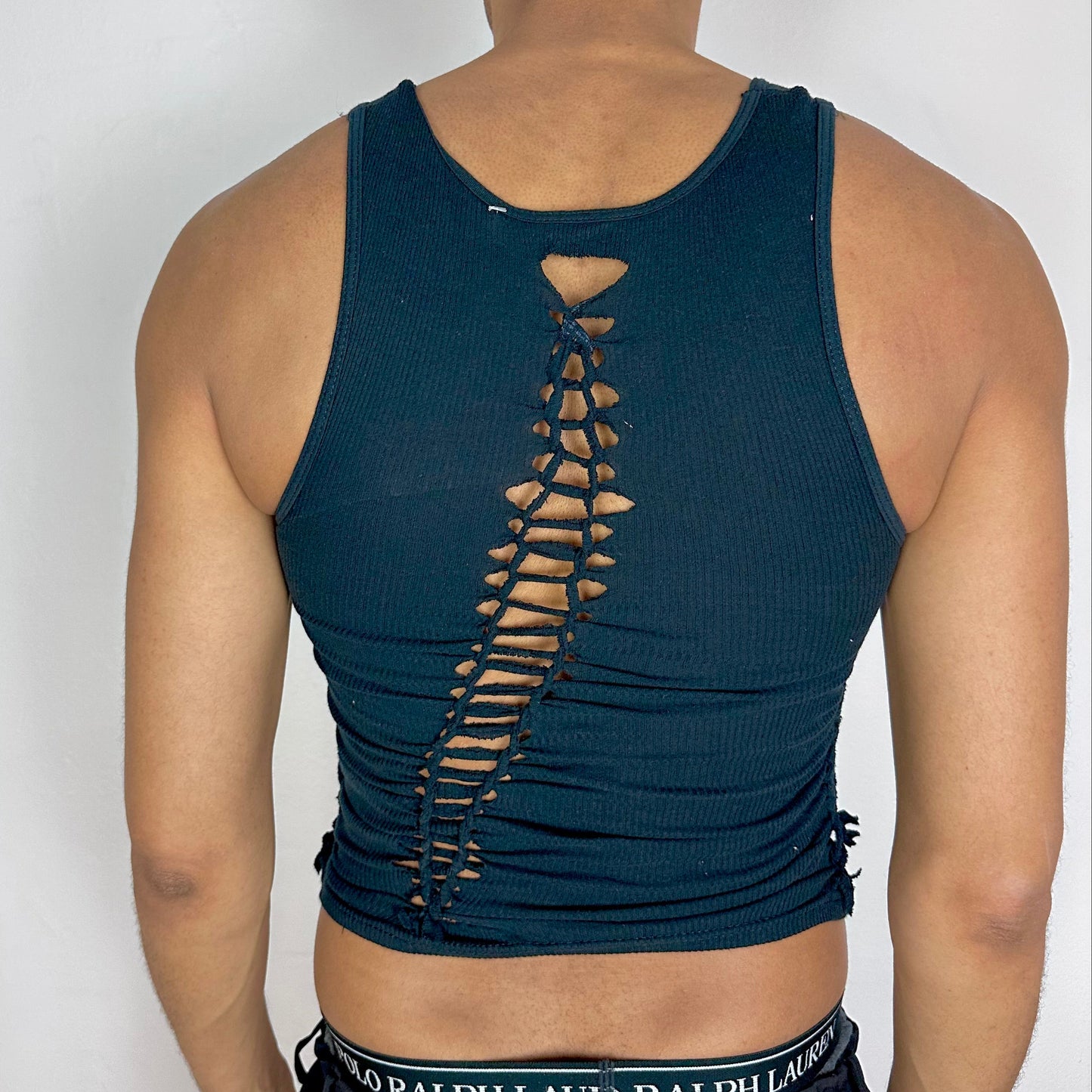 ASTROBOI* x Gildan 'Octavos' black asymmetric braided twist tank top, rear view showing asymmetric strap and braid construction, worn by model.