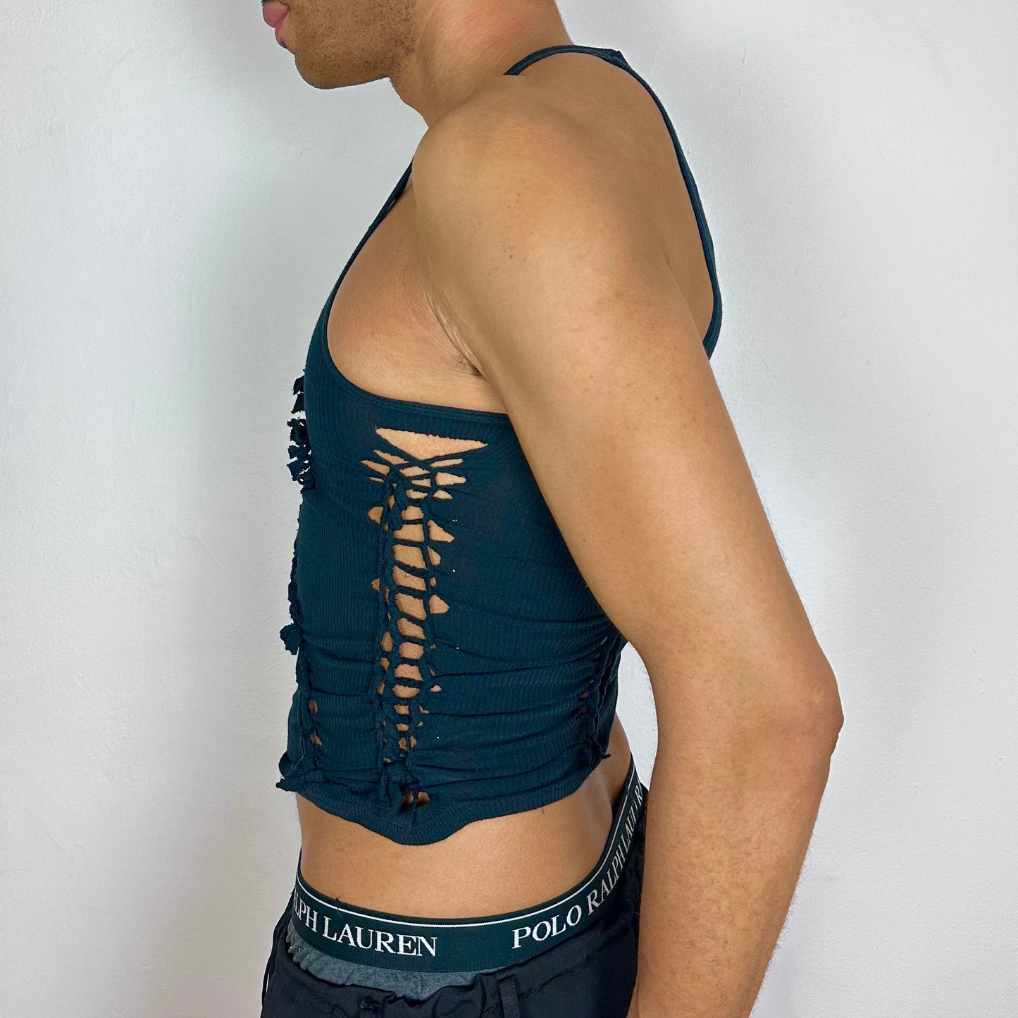Left side detail of ASTROBOI* x Gildan 'Octavos' showing asymmetric braided strap and knotted detailing on black cropped tank.