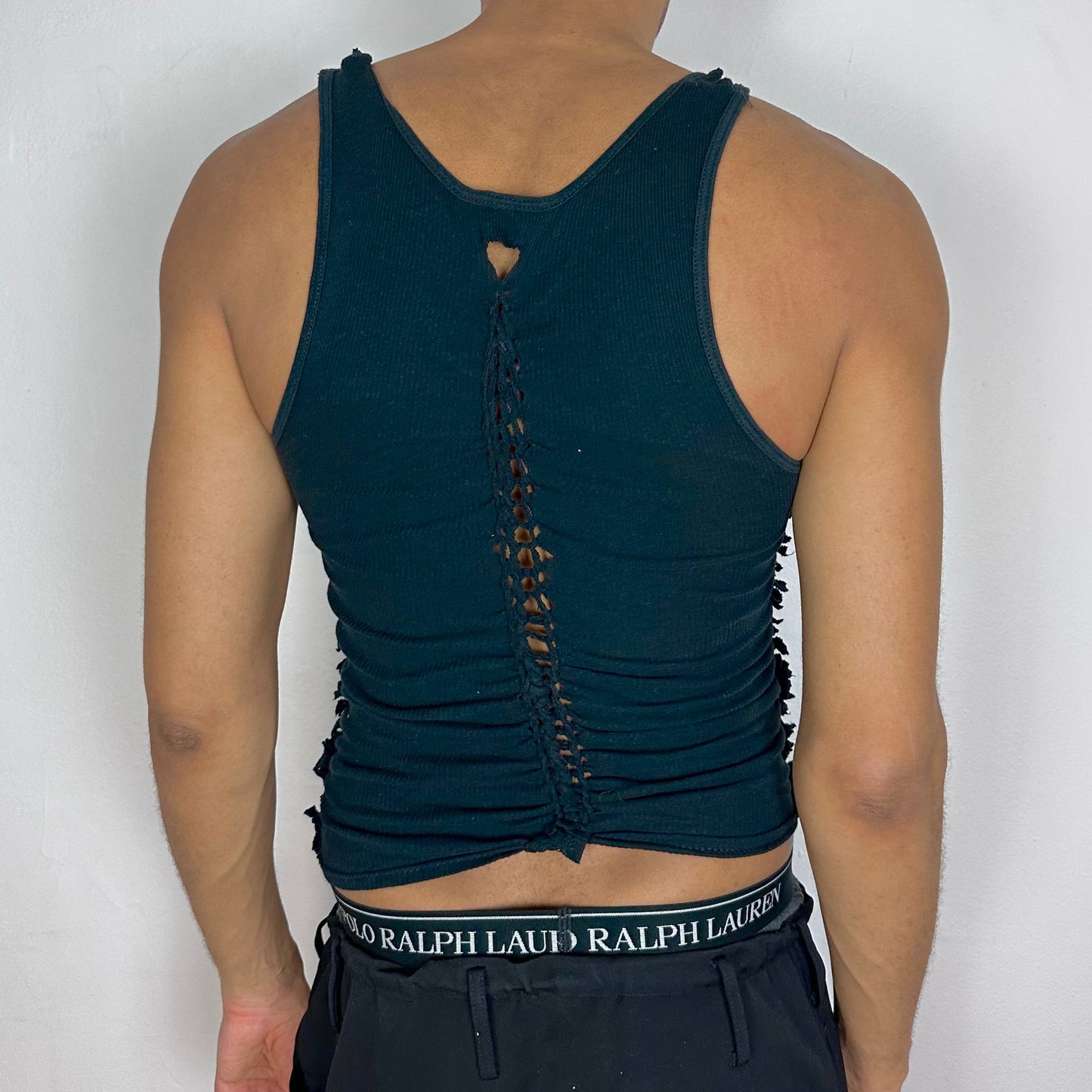 ASTROBOI* 'Jet' black braided twist tank top, rear view showing braid, knot, and cut-out construction, worn by male model.