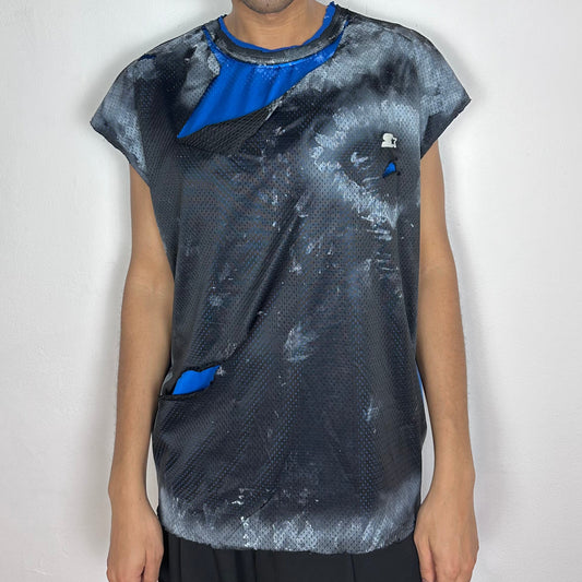 ASTROBOI* x Starter black and blue ripped mesh tank top with artfully ripped outer mesh revealing blue interior layer, white paint detailing, and Starter logo at chest, baggy fit, front view.