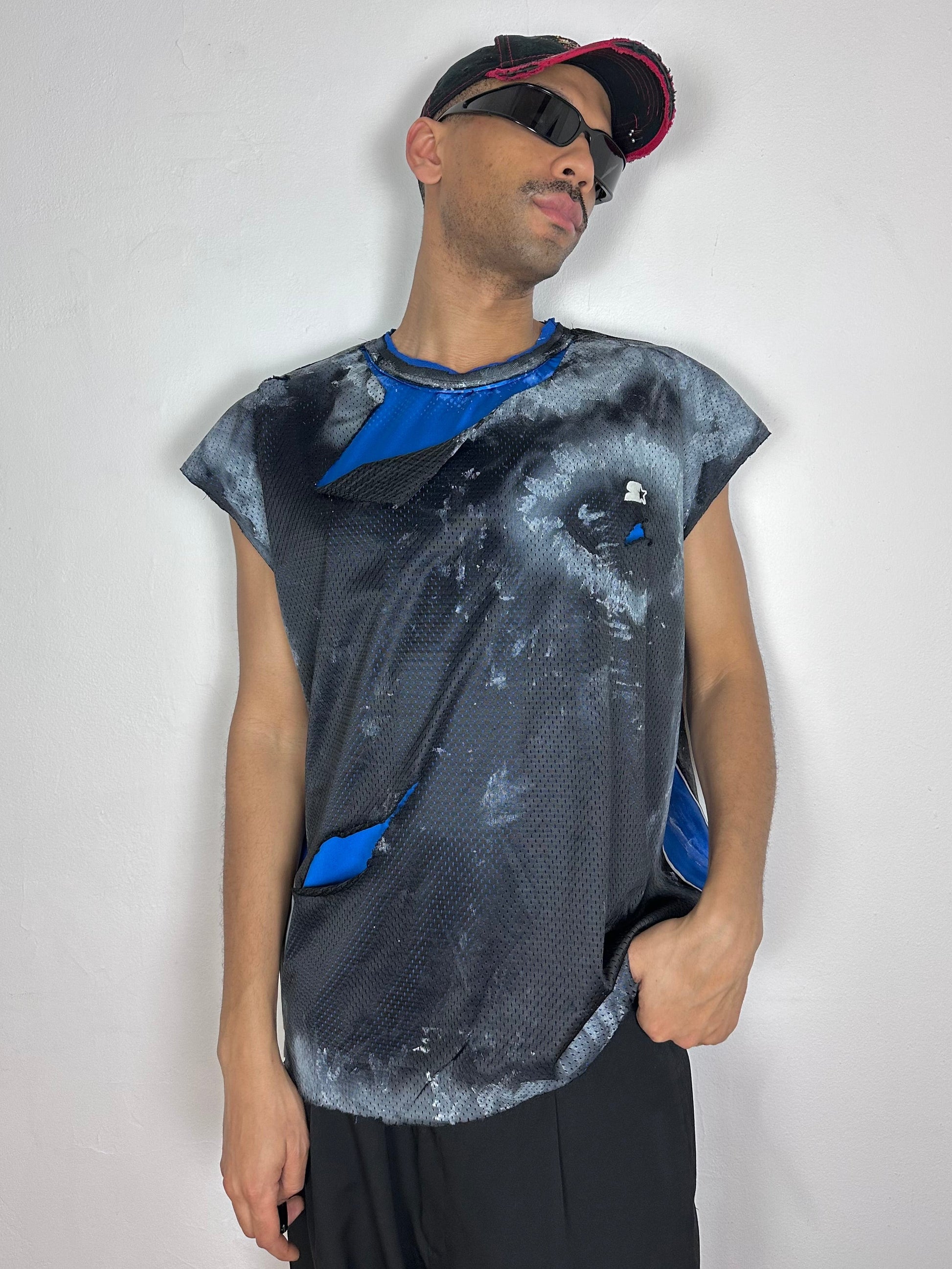 Male model wearing ASTROBOI* x Starter black and blue ripped mesh tank top, styled full look, ASTROBOI* STUDIO NYC.