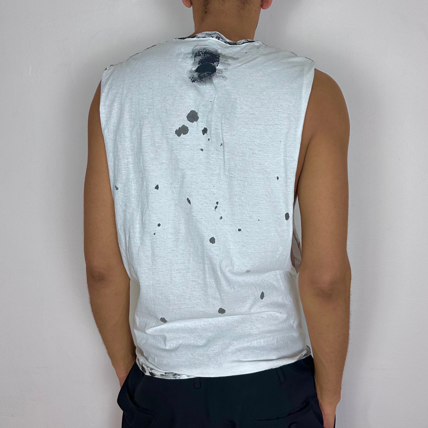ASTROBOI* x Hanes 'Flames' white and black painted muscle shirt, rear view showing hand-drawn scribble and flame tattoo print construction, worn by male model.
