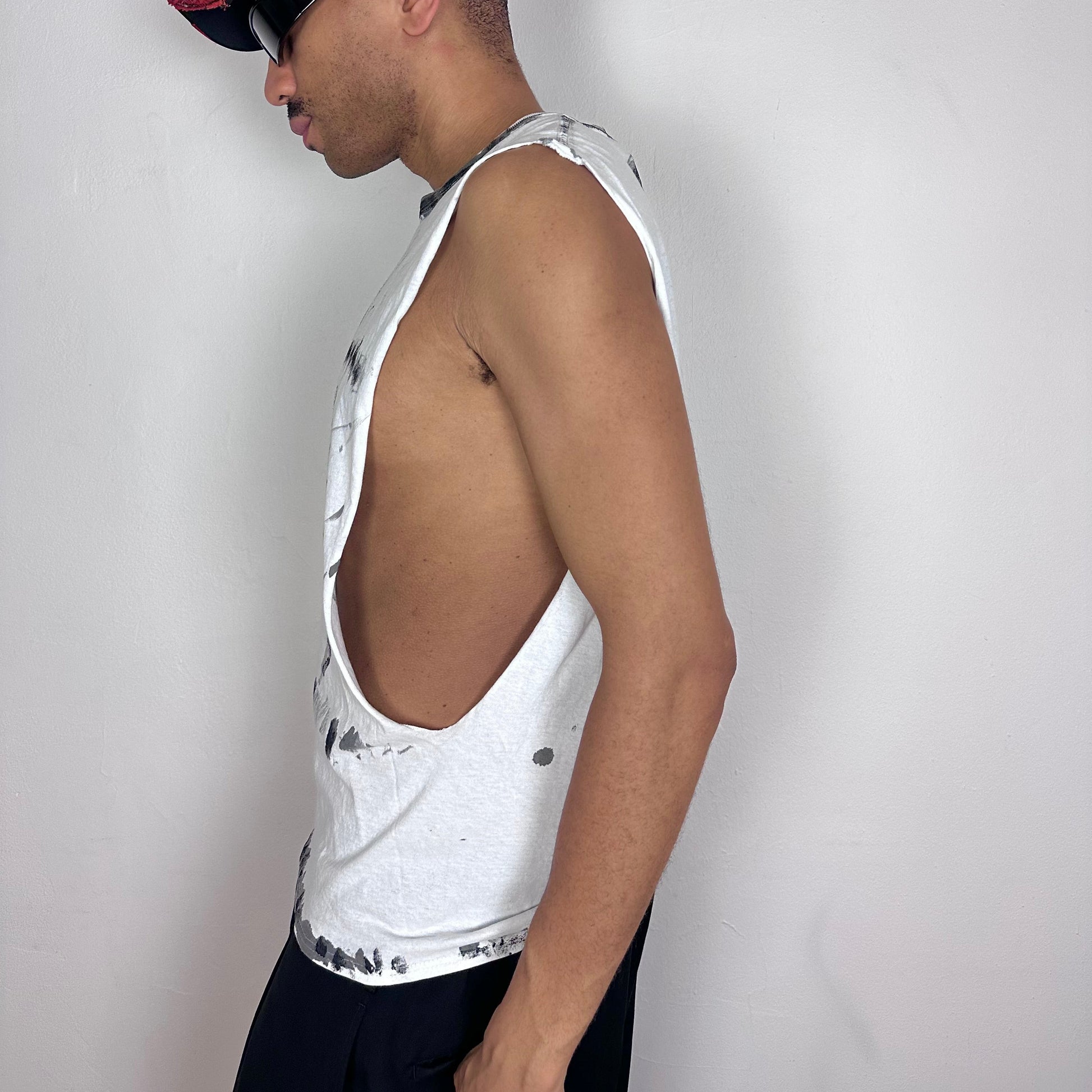  Left side detail of ASTROBOI* x Hanes 'Flames' showing black scribble and flame tattoo print detailing with subtle distressing on white muscle shirt.