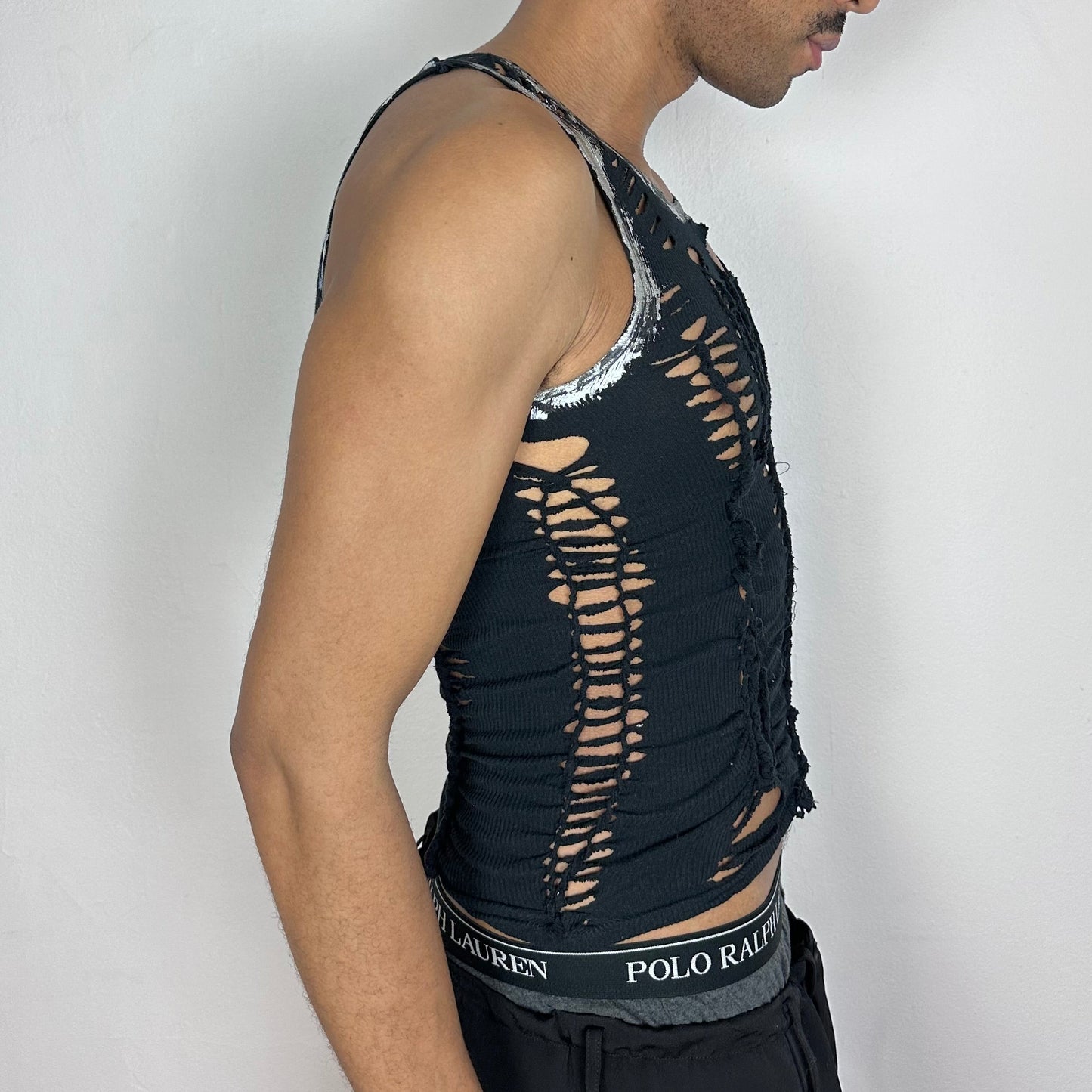 Right side detail of ASTROBOI* 'Zinc' showing silver metallic foiling along arm edge and braided twist construction on slim-fitting black base.