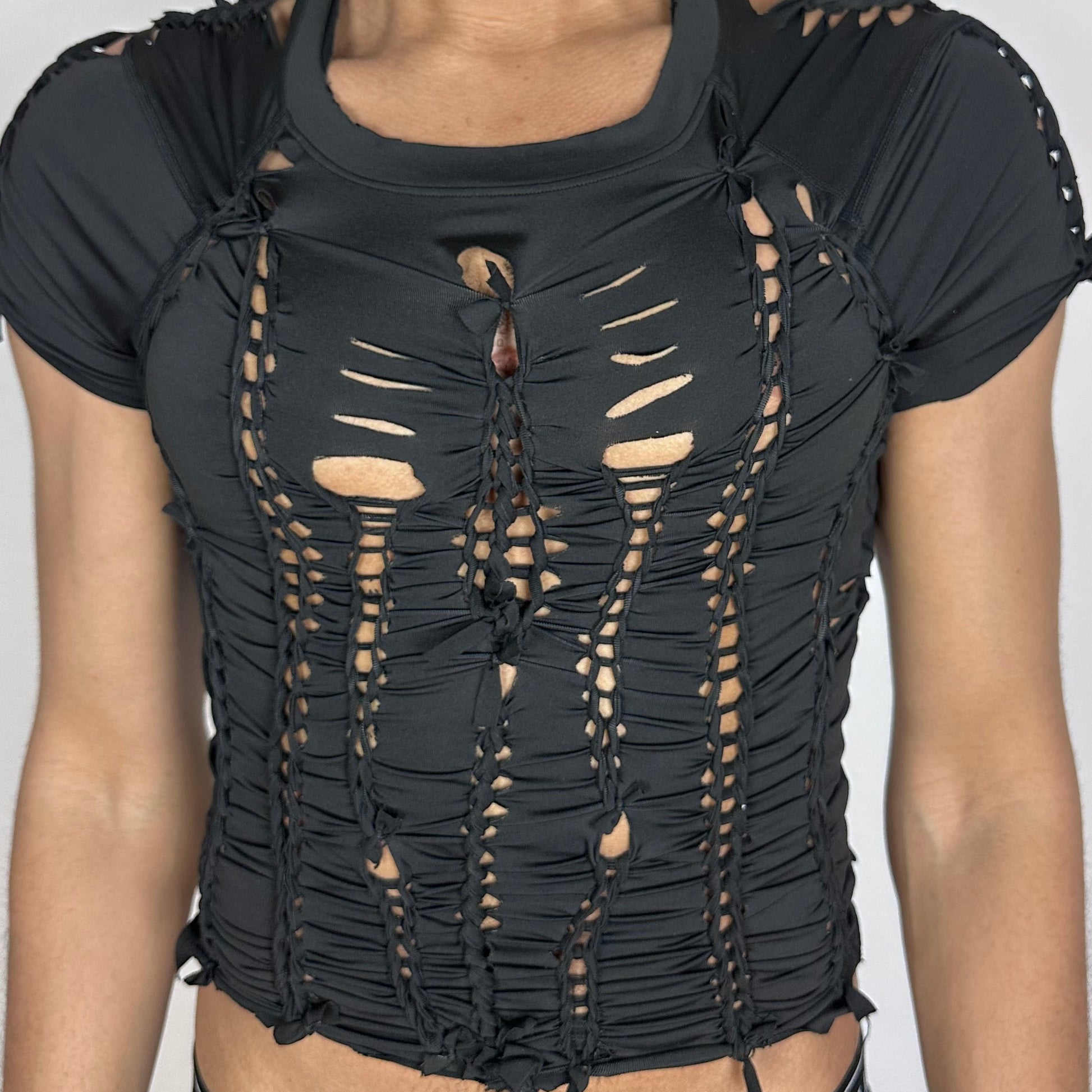 Close-up of ASTROBOI* 'Pandora' showing hand-braided construction and cut-out detailing on black spandex and Lycra fabric.