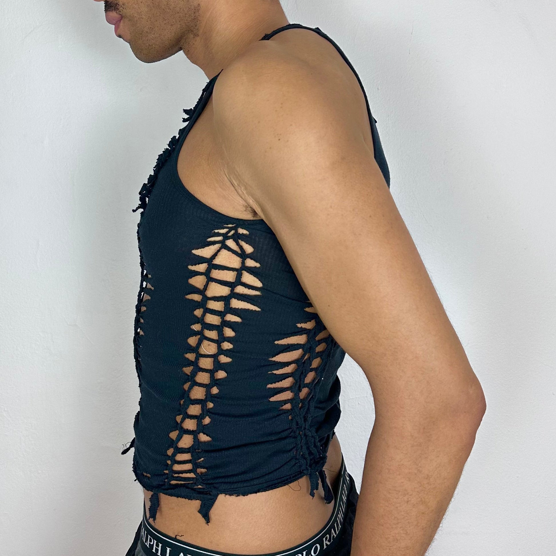 Left side detail of ASTROBOI* 'Morningstar' showing hand-braided arrangement, knot detail, and cut-outs on cropped black cotton tank.