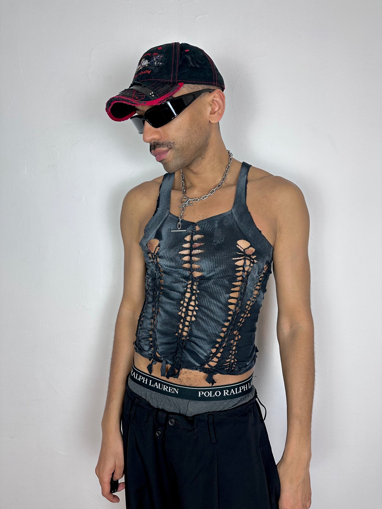 Male model wearing ASTROBOI* 'Magus' black and white G-Unit braided Y2K tank top, styled full look, ASTROBOI* STUDIO NYC.