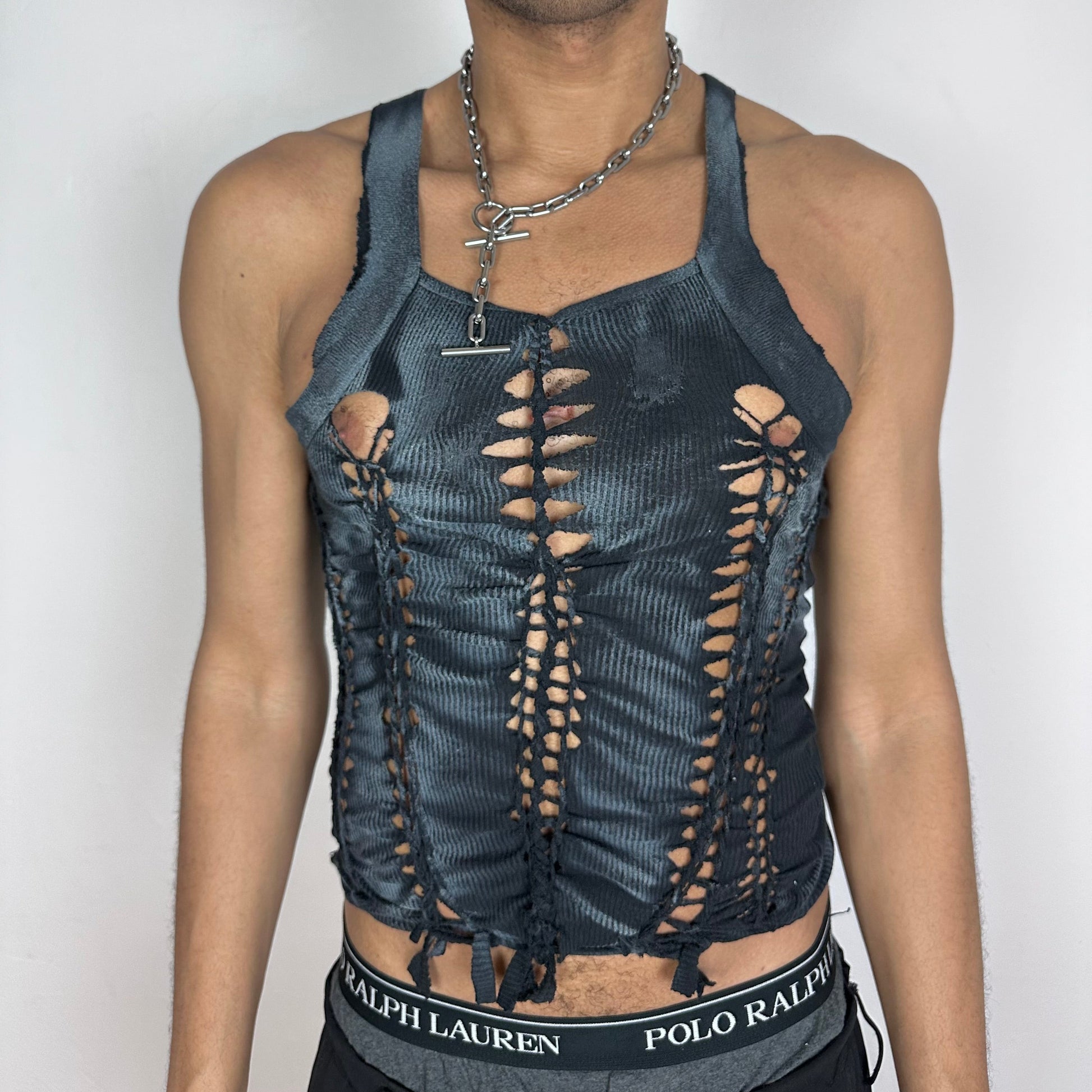 ASTROBOI* 'Magus' black slim-fitting Y2K braided twist tank top with slash detailing, white paint accents, and G-Unit inspired shoulder-emphasizing design, front view.