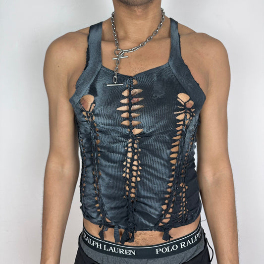 ASTROBOI* 'Magus' black slim-fitting Y2K braided twist tank top with slash detailing, white paint accents, and G-Unit inspired shoulder-emphasizing design, front view.