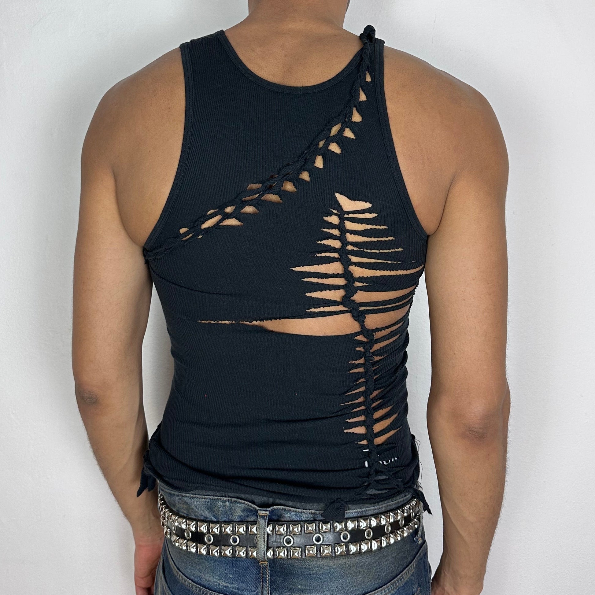 ASTROBOI* 'Highbeam' black braided twist tank top, rear view showing braid, cut-out, and fringe hem construction, worn by male model.