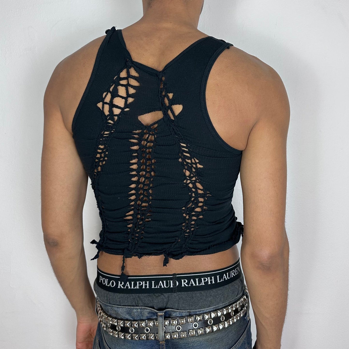 ASTROBOI* 'Andromeda' black braided twist tank top, rear view showing braid and cut-out construction, worn by male model.