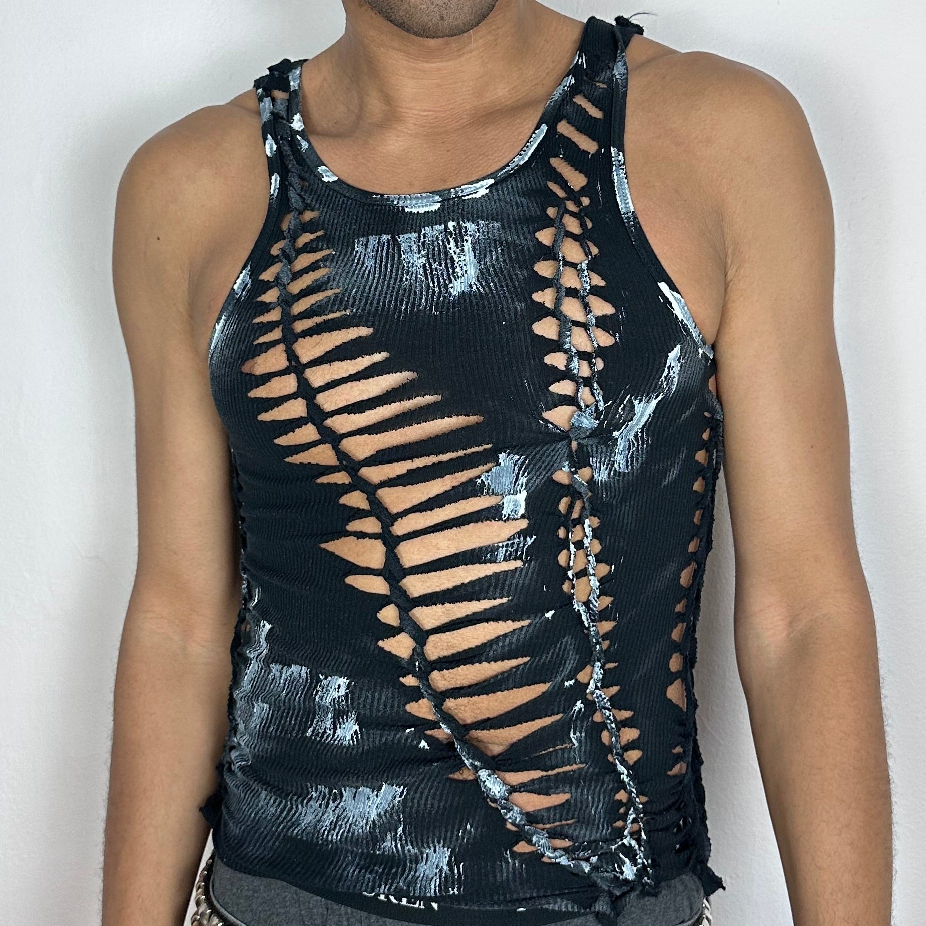 Close-up of ASTROBOI* 'Oreo' showing black hand-braided texture, cut-out detailing, and white painterly abstract design on torso.