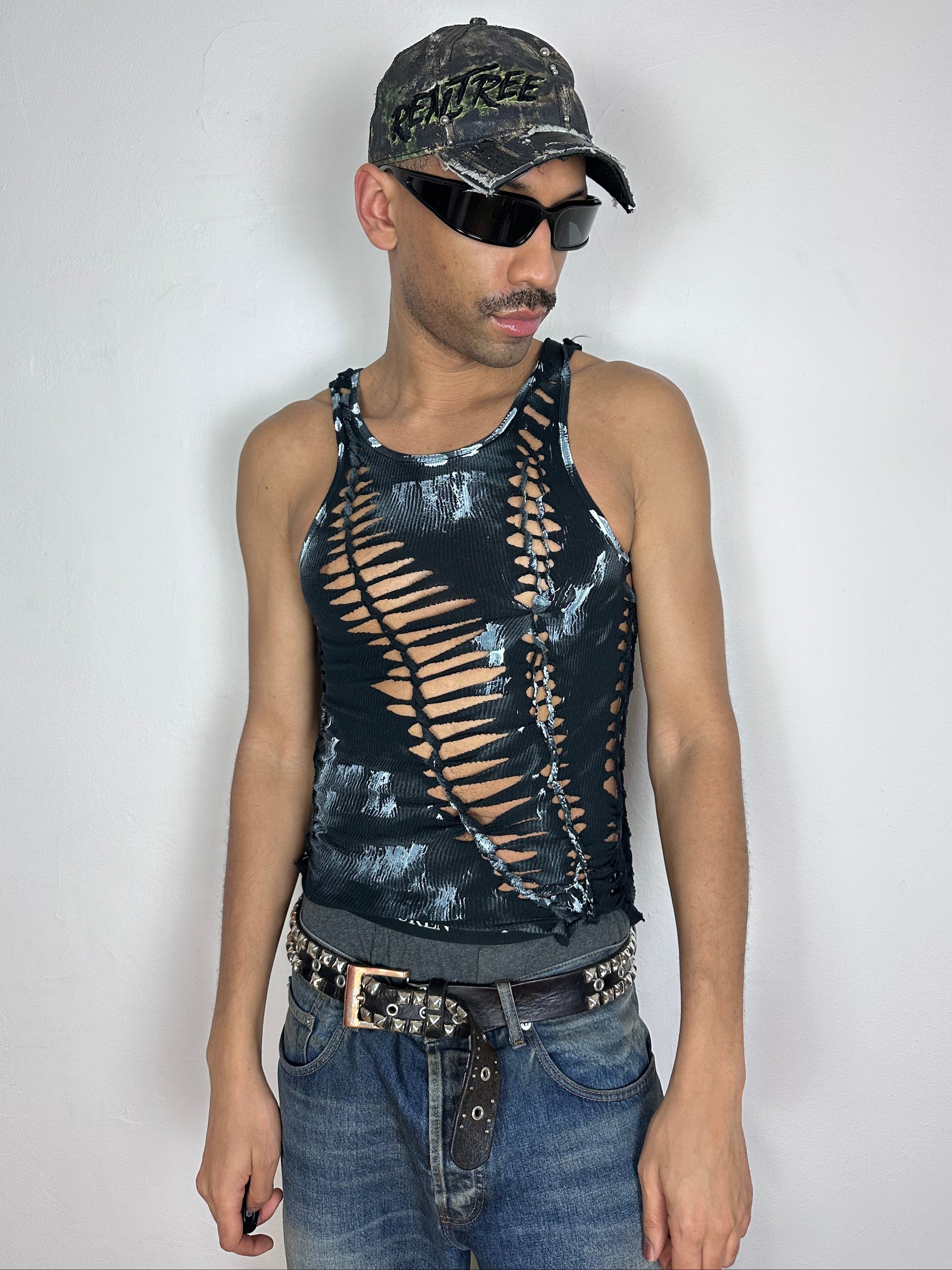 Male model wearing ASTROBOI* 'Oreo' black and white braided cut-out tank top, styled full look, ASTROBOI* STUDIO NYC.