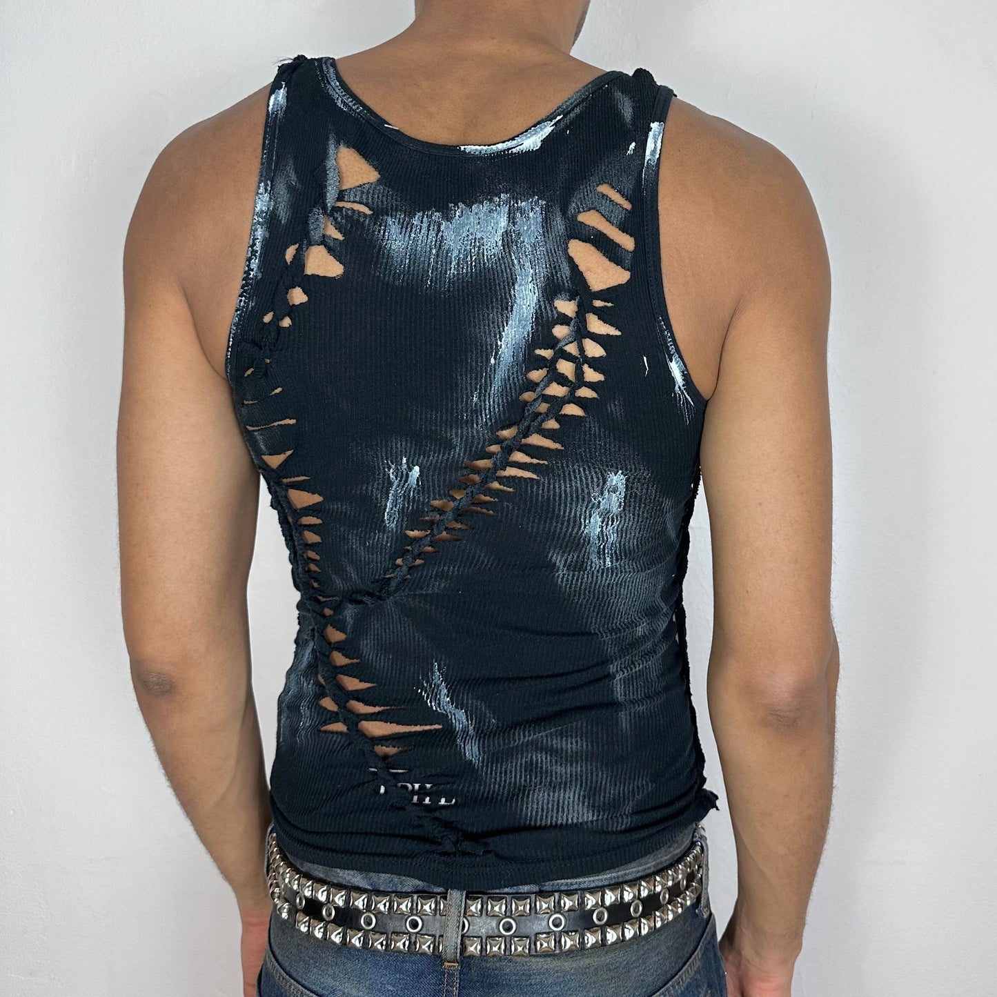 ASTROBOI* 'Oreo' black and white braided cut-out tank top, rear view showing braid and cut-out construction, worn by male model.