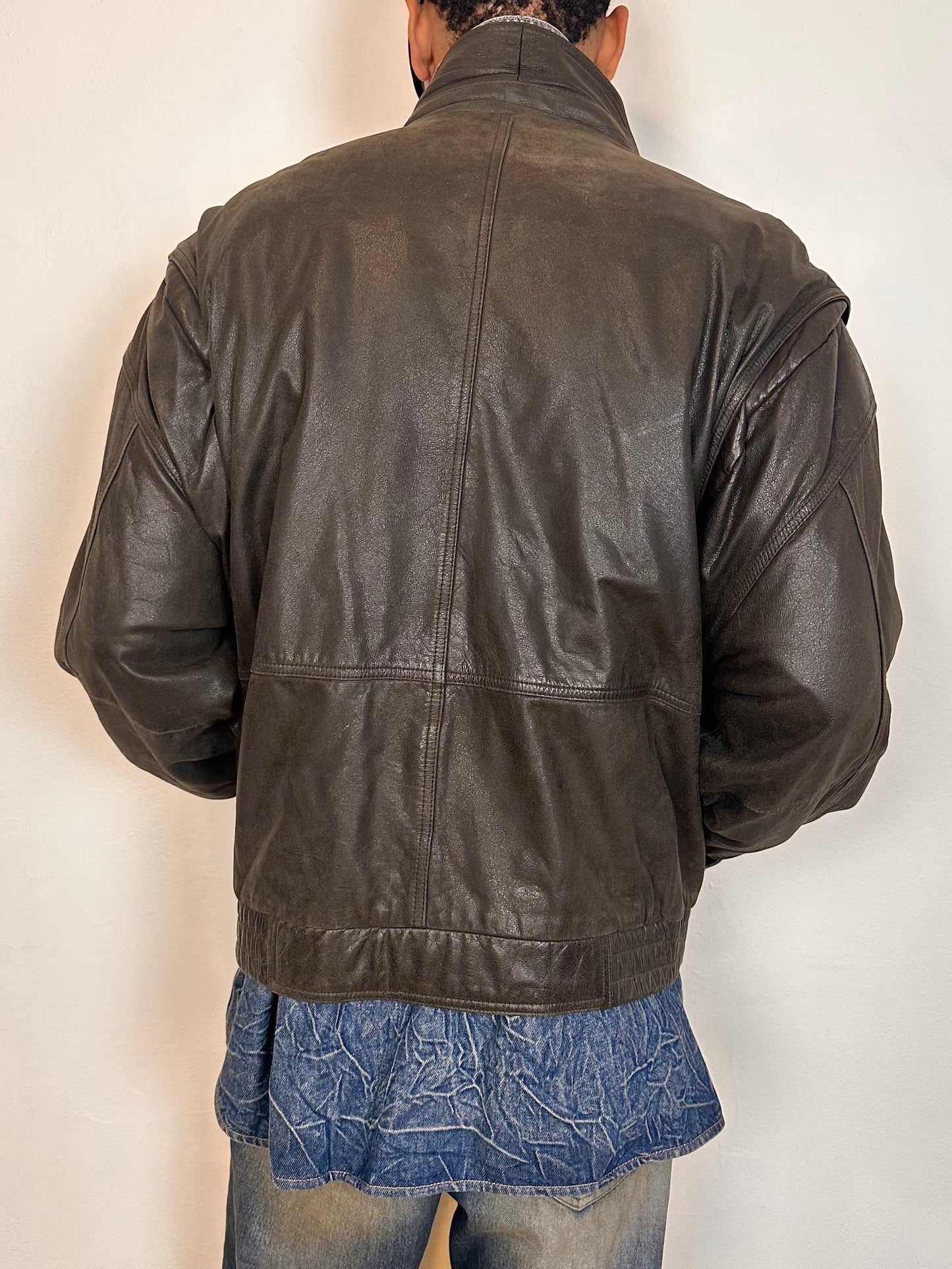 Back of Vintage Canton Ridge brown leather bomber jacket with ribbed cuffs, elastic hem, relaxed fit, and multiple pockets, fits like XL.