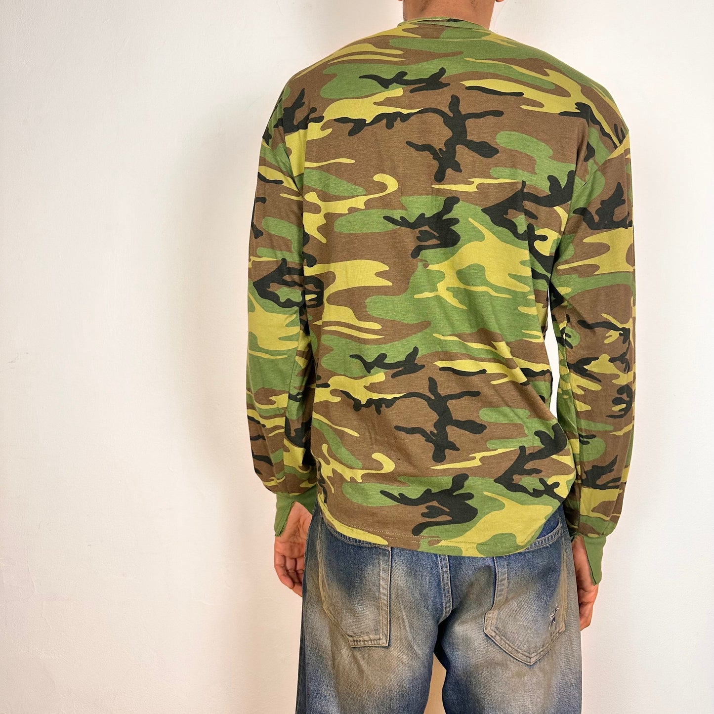 Back side of ASTROBOI* green camouflage T-shirt with braided detailing, tonal rhinestone collar, raw hem, and loose fit, handmade in NYC.