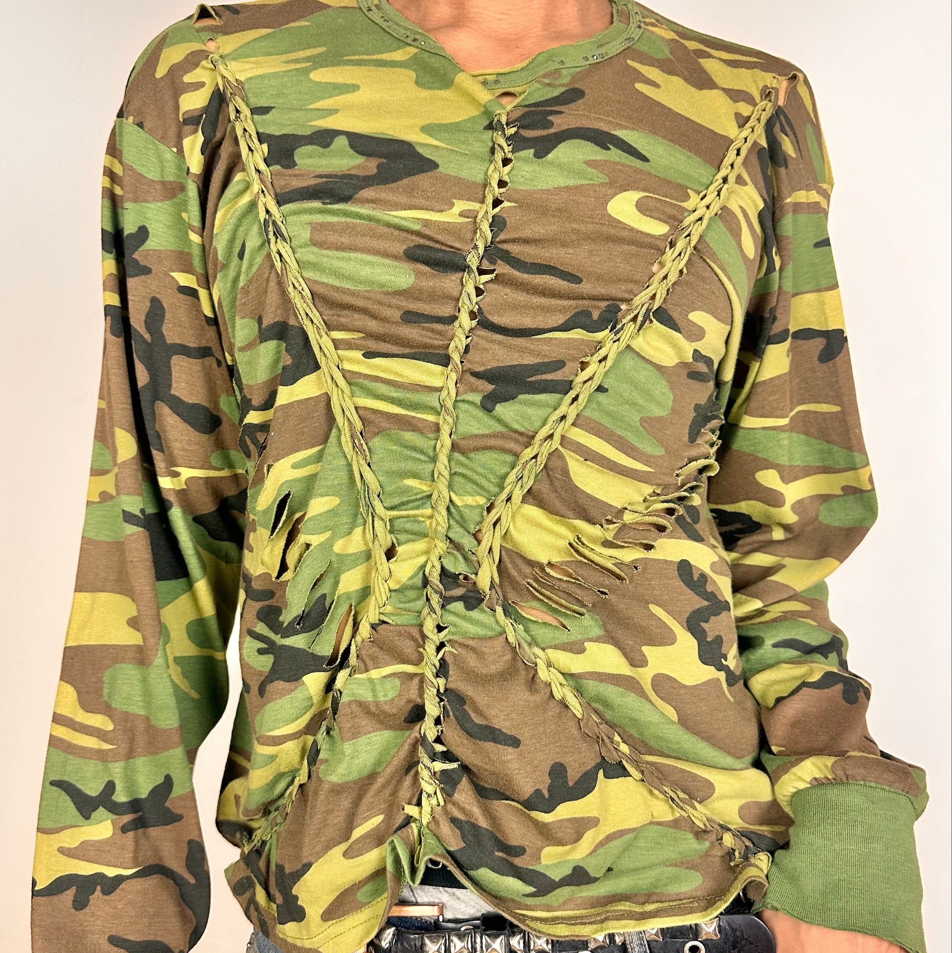 CLose up of front details on ASTROBOI* green camouflage T-shirt with braided detailing, tonal rhinestone collar, raw hem, and loose fit, handmade in NYC.