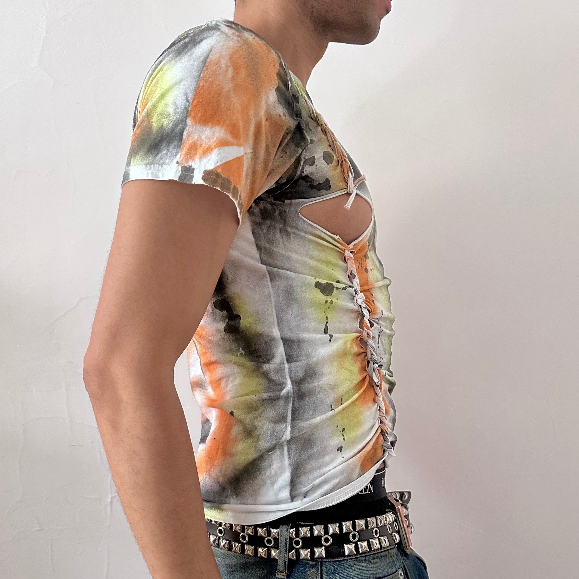 Right side detail of ASTROBOI* x Gildan 'Orange Haze' showing abstract paint design and subtle braid detailing on white heavyweight cotton base.