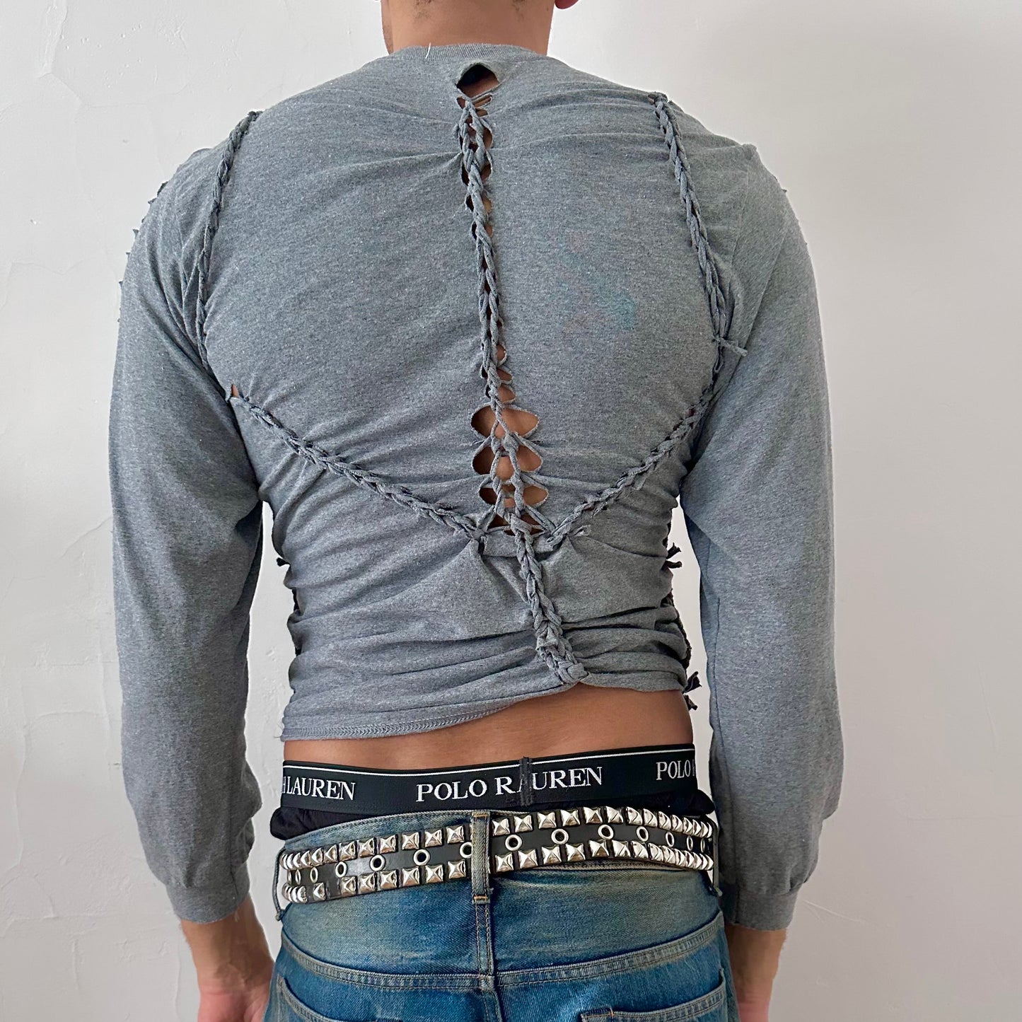 ASTROBOI* x Gildan 'Sl8' gray braided twist long sleeve t-shirt, rear view showing braid, knot, and cut-out construction, worn by male model.