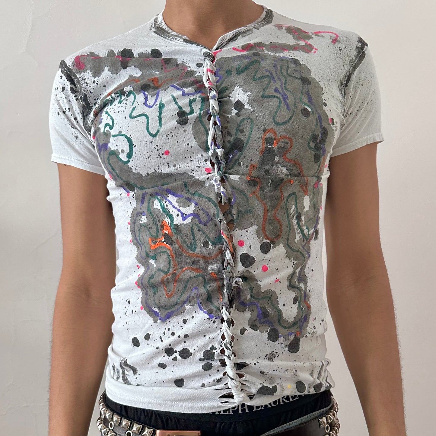Close-up of ASTROBOI* x Hanes 'Multicolor' showing multicolor scribble confetti paint design and single center braid detail on white cotton fabric.