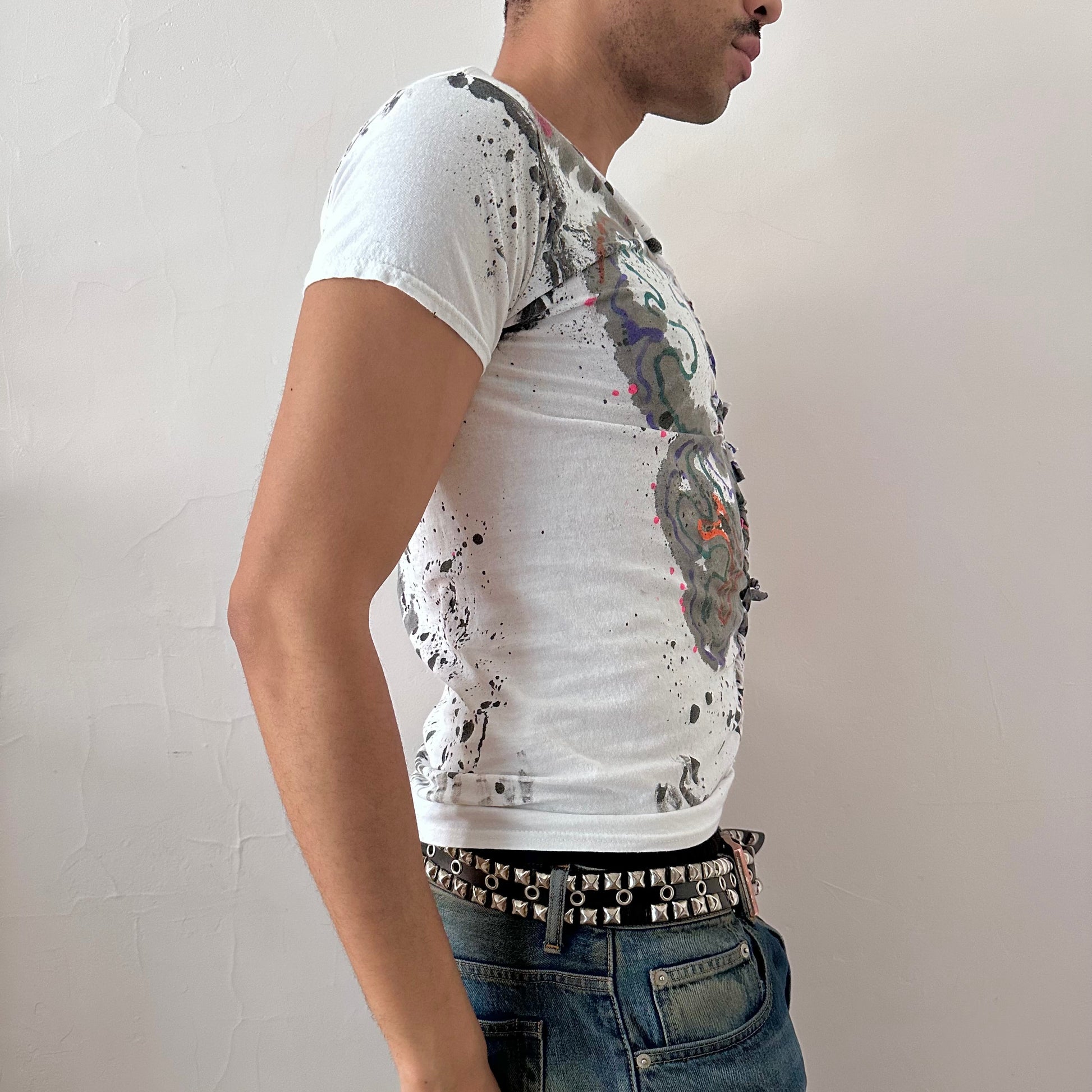 Right side detail of ASTROBOI* x Hanes 'Multicolor' showing multicolor scribble confetti paint design on loose-fitting white cotton base.
