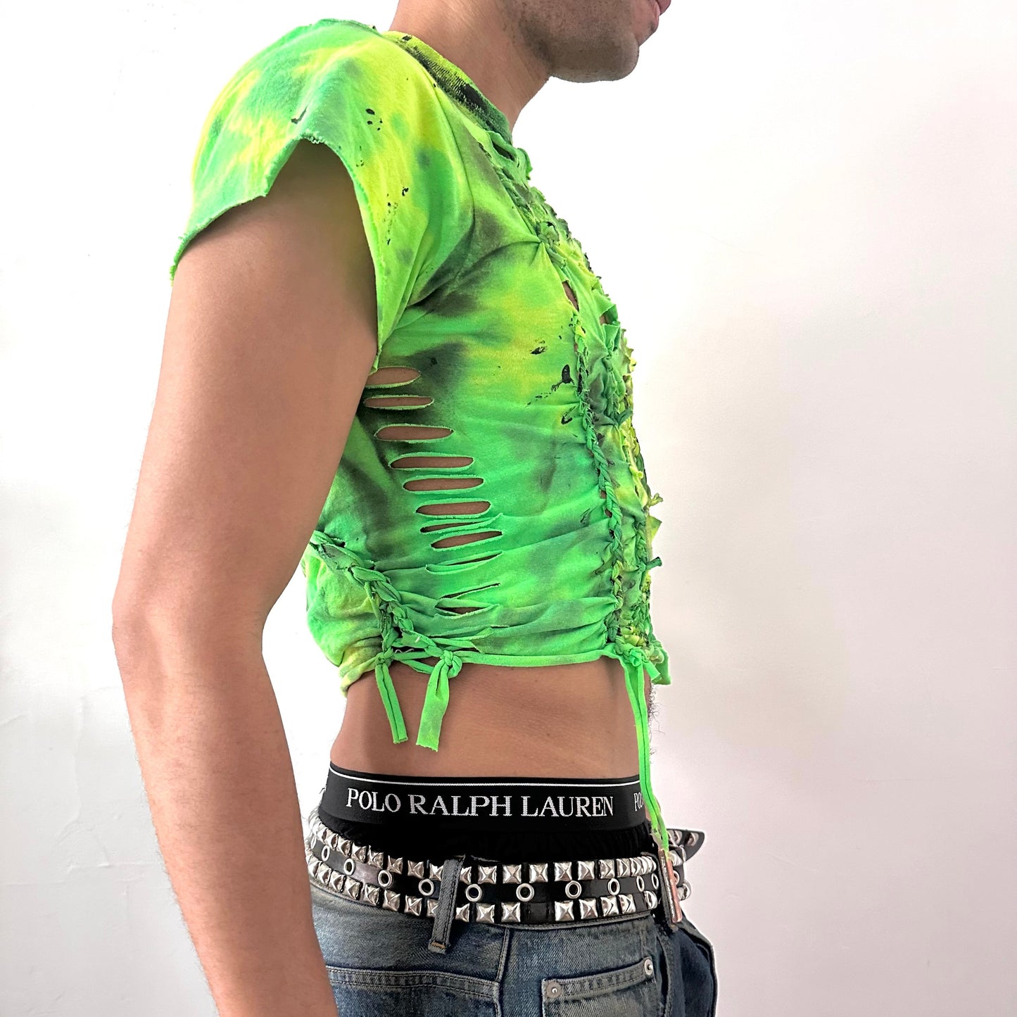 Right side detail of ASTROBOI* x Gildan 'Sage Pulse' showing neon green tie dye pattern and black tar paint detail on close-fitting braided cotton base.