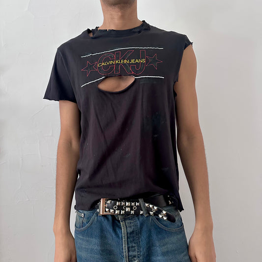 ASTROBOI* x CK Jeans black loose-fitting asymmetric logo t-shirt with CK Jeans logo across chest, asymmetric sleeves, and uneven hem, front view.