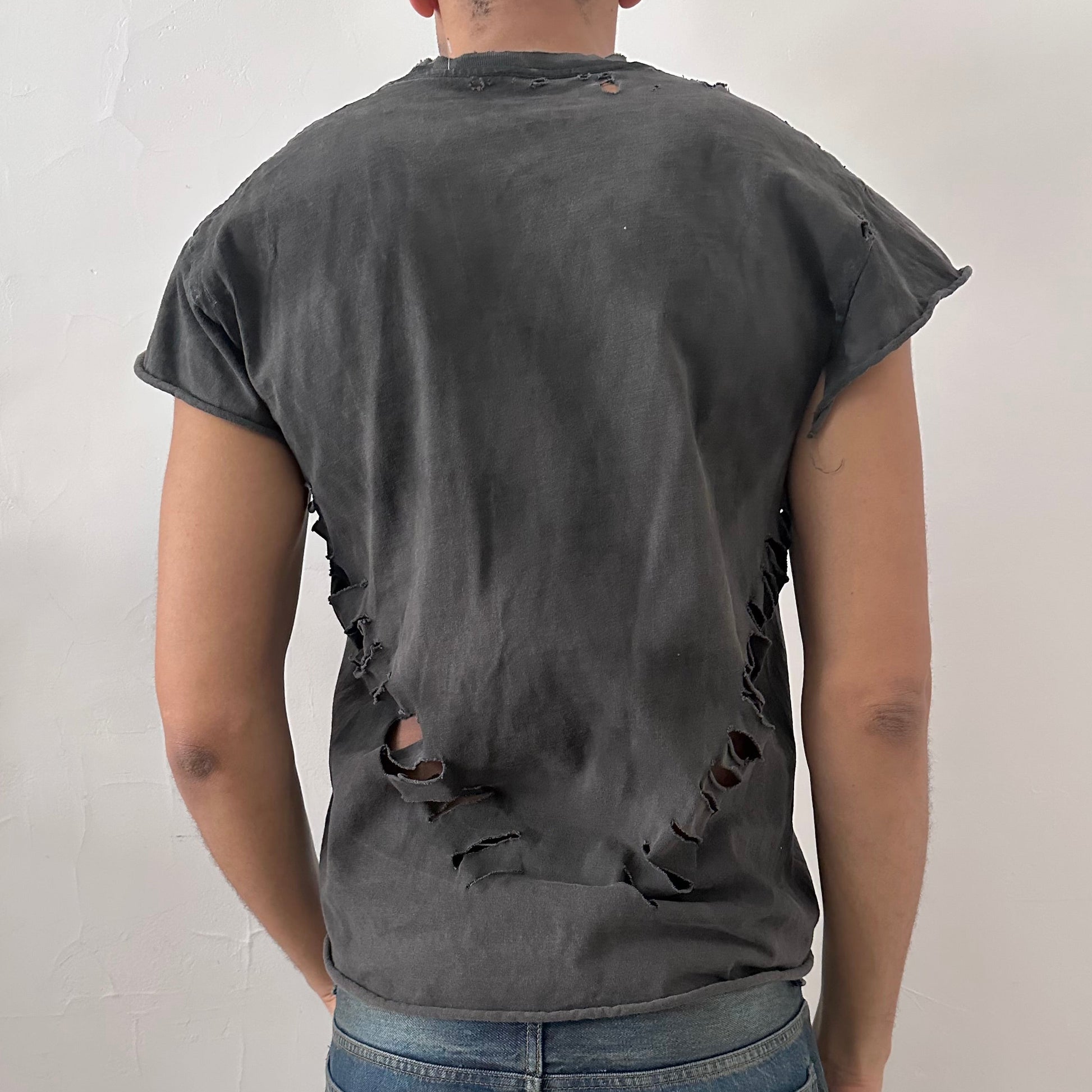 ASTROBOI* NCAA Basketball black ripped muscle tank top, rear view showing distressed holes and raw edge construction, worn by male model.