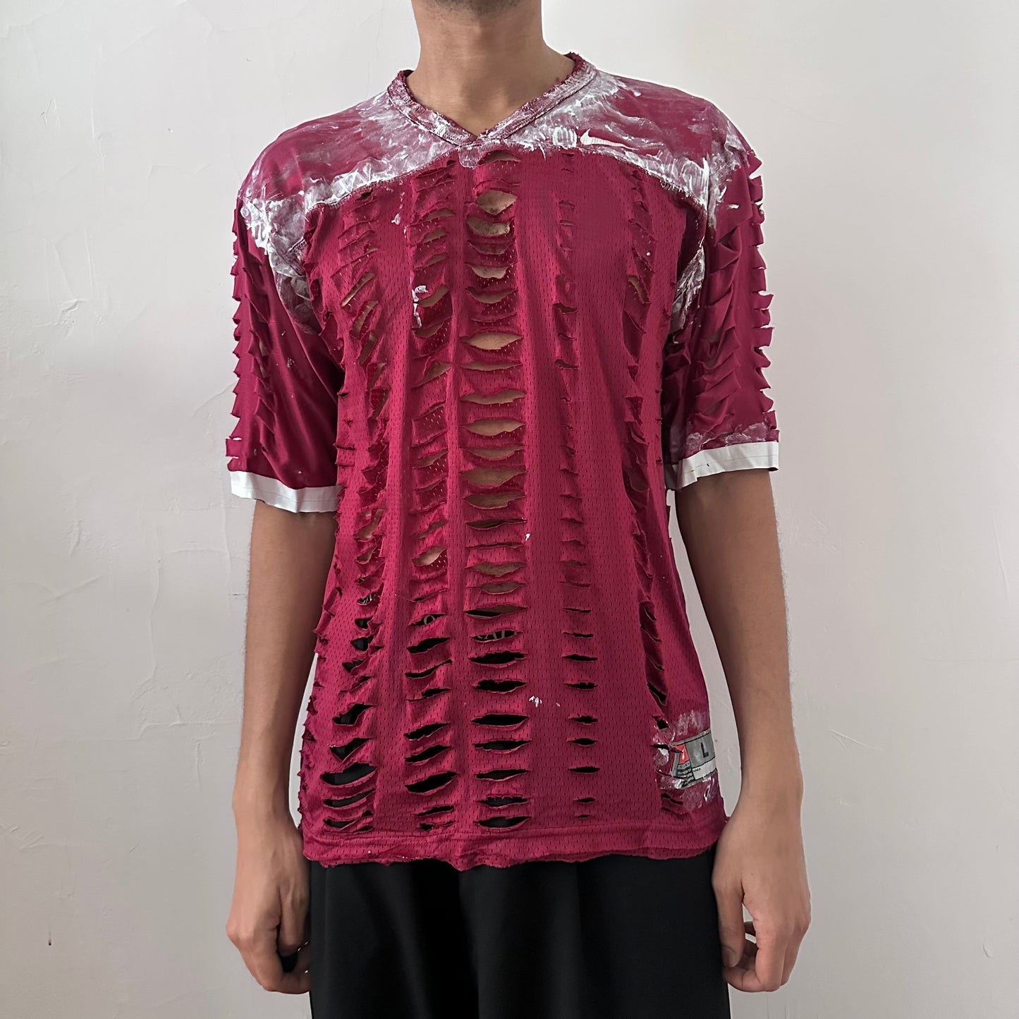 ASTROBOI* x Nike 'BloodThirst' maroon loose-fitting mesh jersey with white painterly details throughout and raw hem, front view.
