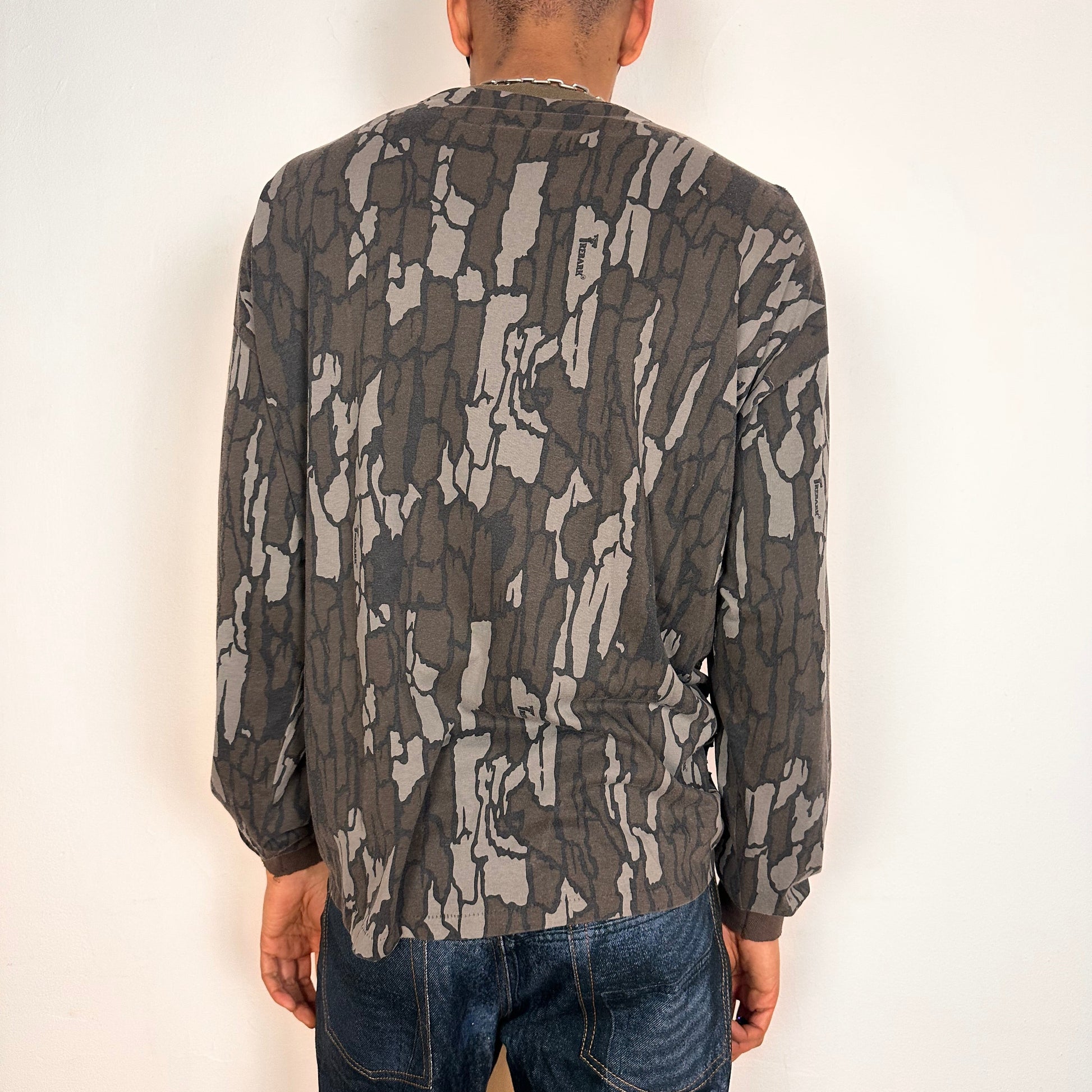Back of ASTROBOI* gray camouflage long sleeve T-shirt with braided torso detailing, rhinestone neckline, raw hem, and chest pocket, handmade in NYC.