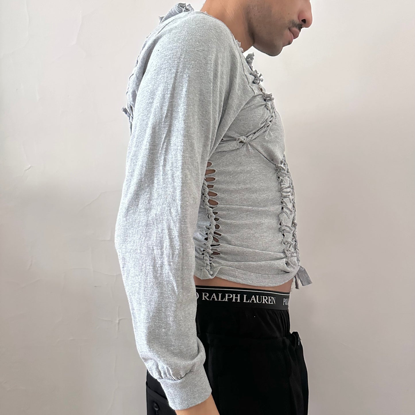 Right side detail of ASTROBOI* x Gildan 'Neutral' showing braided twist, knot, and cut-out construction on heavyweight gray cotton base.