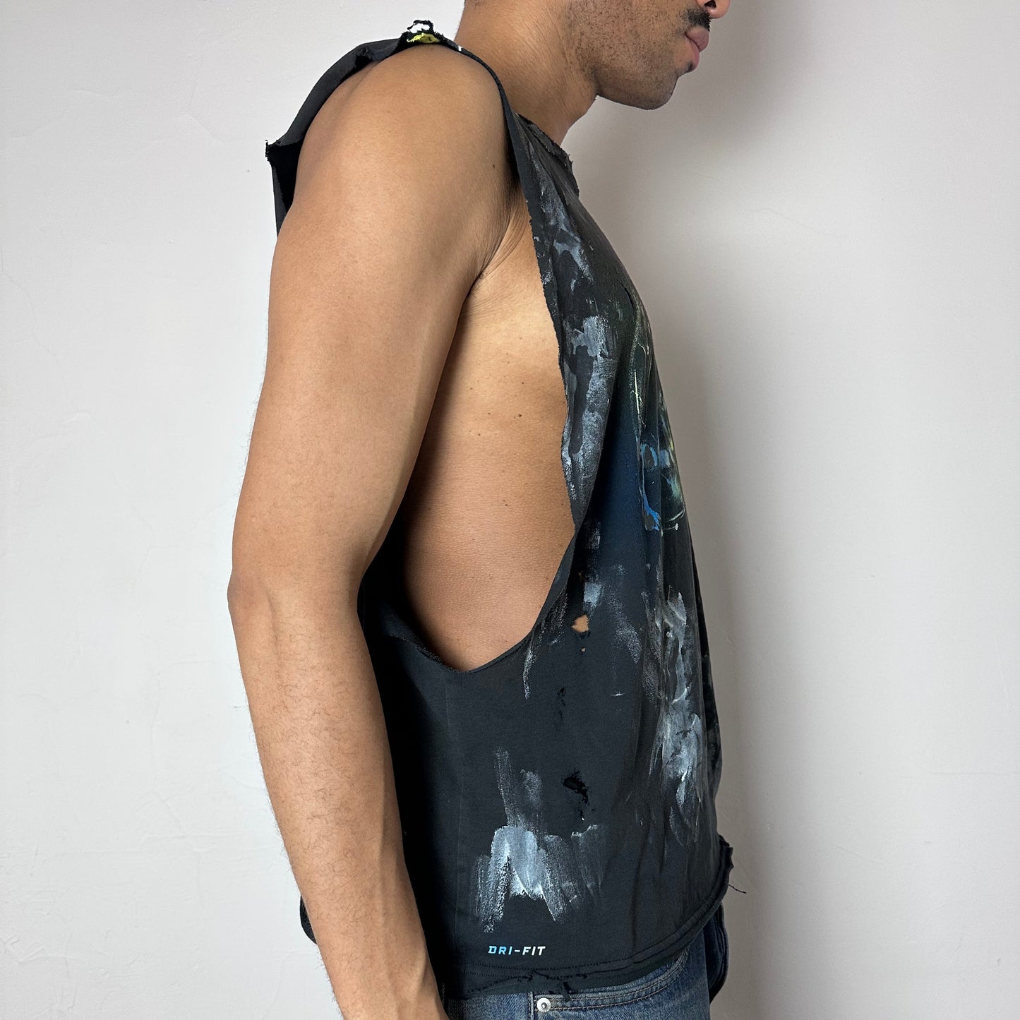 Right side detail of ASTROBOI* x Nike 'Celestial' showing white and black brushstroke paint detailing and raw hem on relaxed-fit navy base.