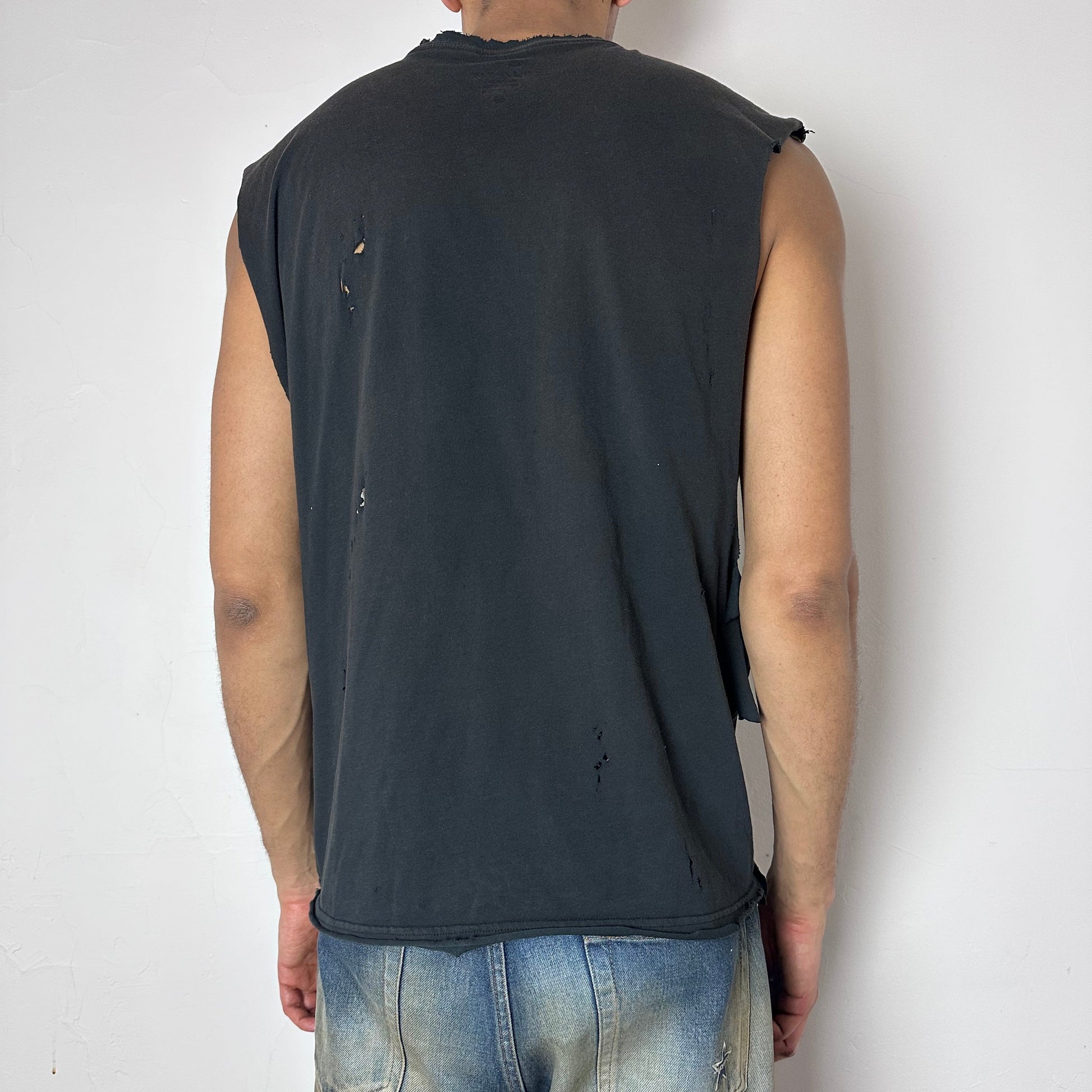 ASTROBOI* x Nike 'Celestial' navy football graphic sleeveless muscle shirt, rear view showing brushstroke paint detail and raw hem, worn by male model.