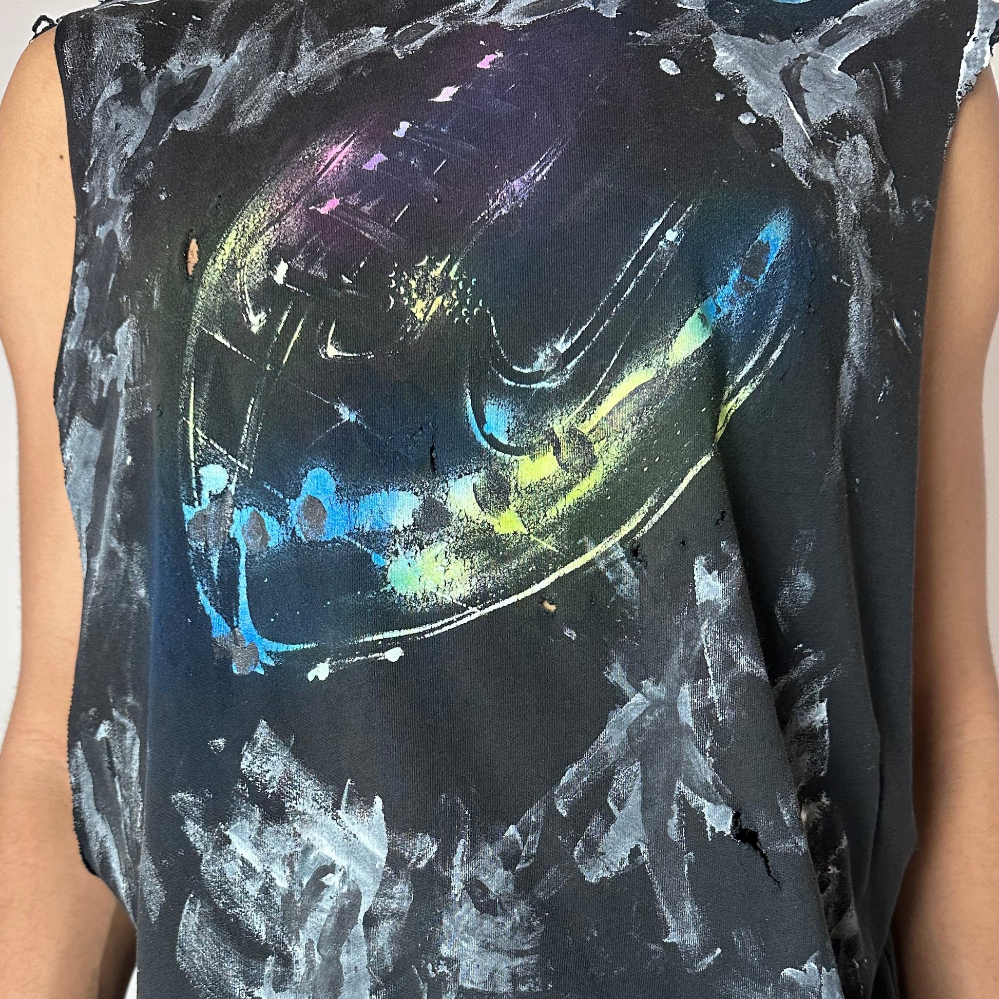 Close-up of ASTROBOI* x Nike 'Celestial' showing centered football graphic and white and black painterly brushstroke detail on navy fabric.