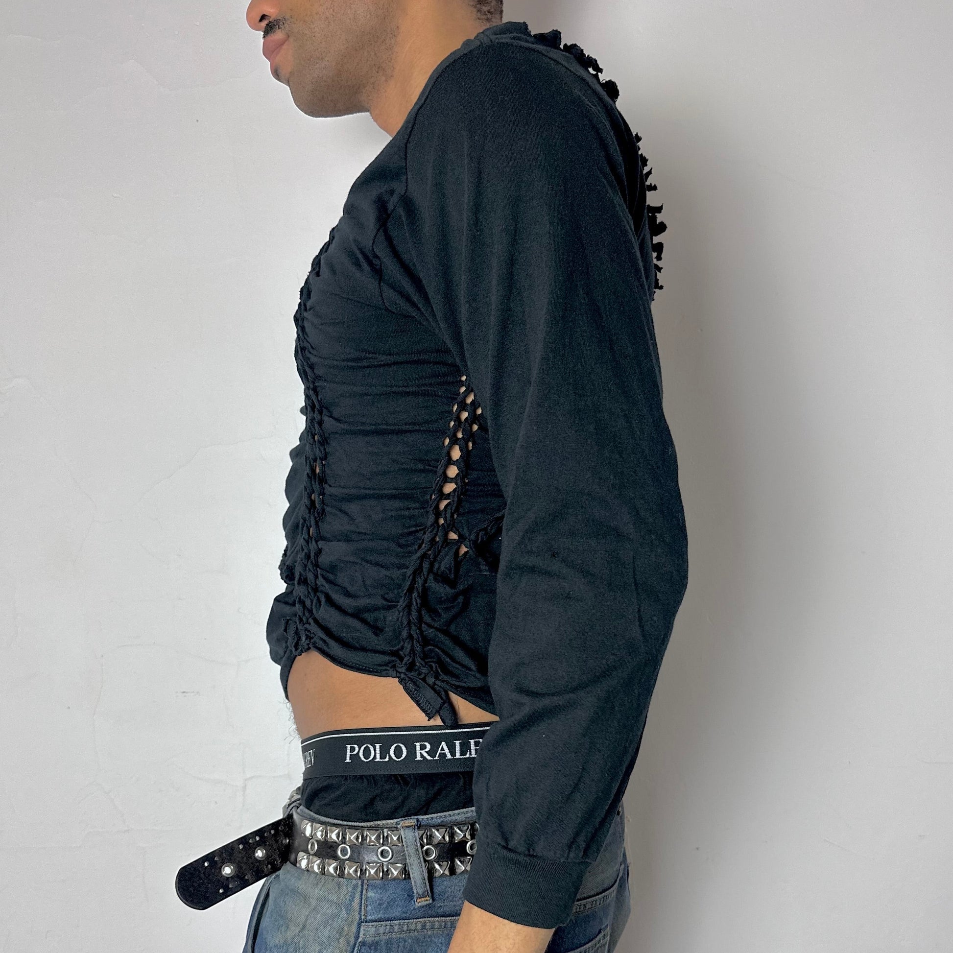 Left side detail of ASTROBOI* x Hanes 'Svart' showing modest hand-braided arrangement and knotted detailing on cropped black long sleeve.
