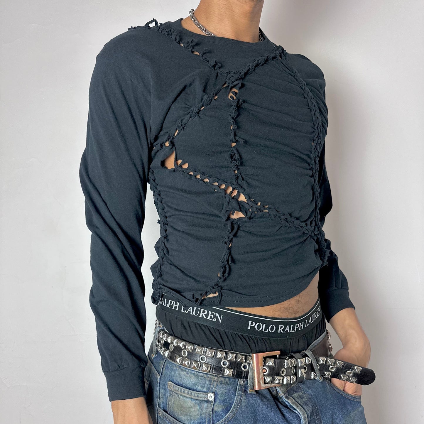 Close-up of ASTROBOI* x Hanes 'Svart' showing modest hand-braided construction and knotted detailing on black 100% cotton fabric.