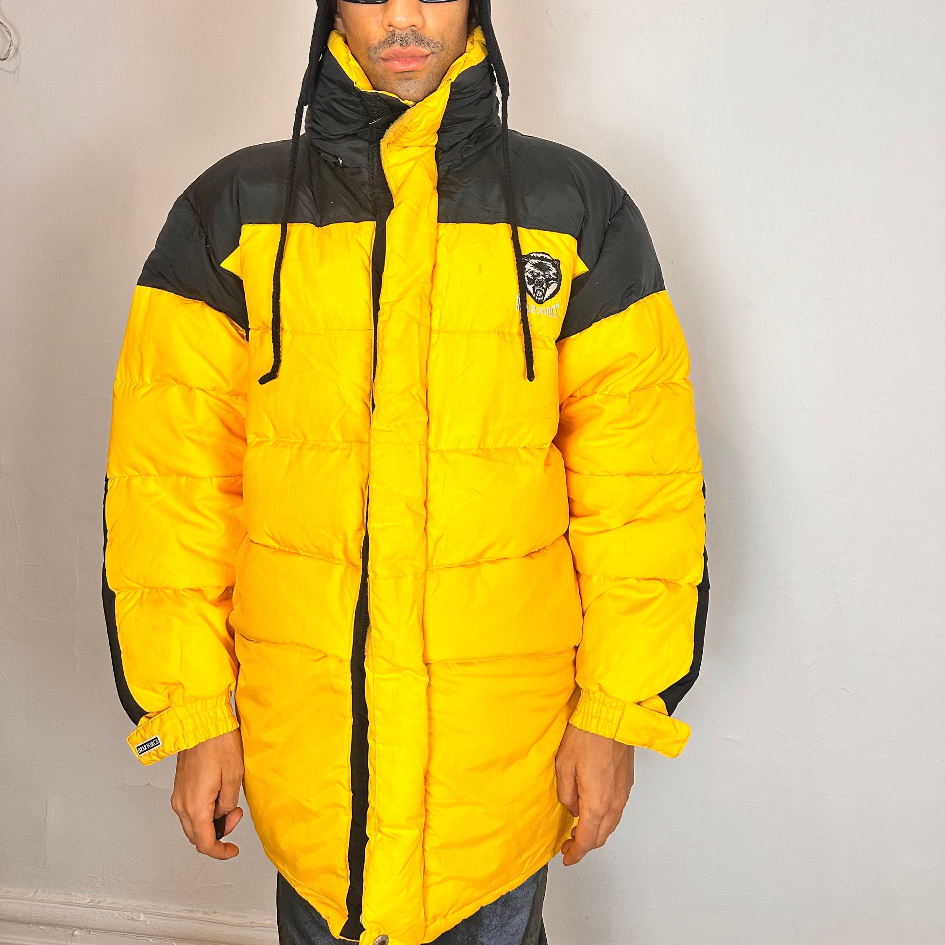 Cover of Bear Mountain yellow puffer jacket with oversized architectural fit, chest logo detail, super warm insulation, size XL.