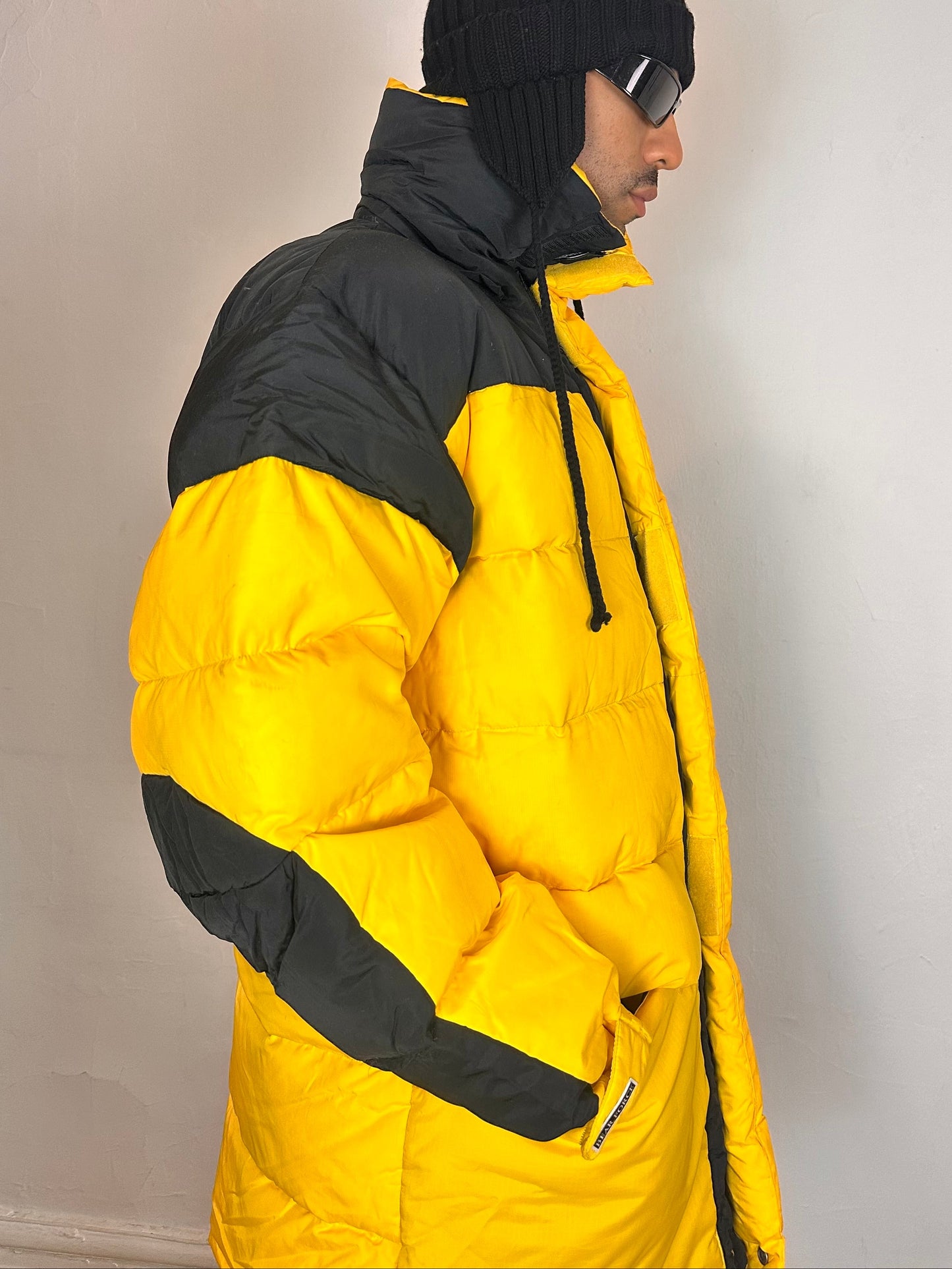 Right side of Bear Mountain yellow puffer jacket with oversized architectural fit, chest logo detail, super warm insulation, size XL.