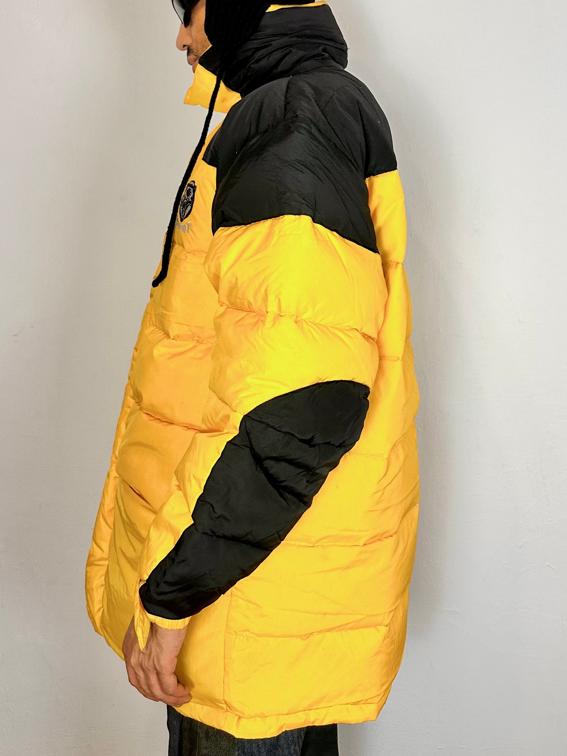 Left side of Bear Mountain yellow puffer jacket with oversized architectural fit, chest logo detail, super warm insulation, size XL.