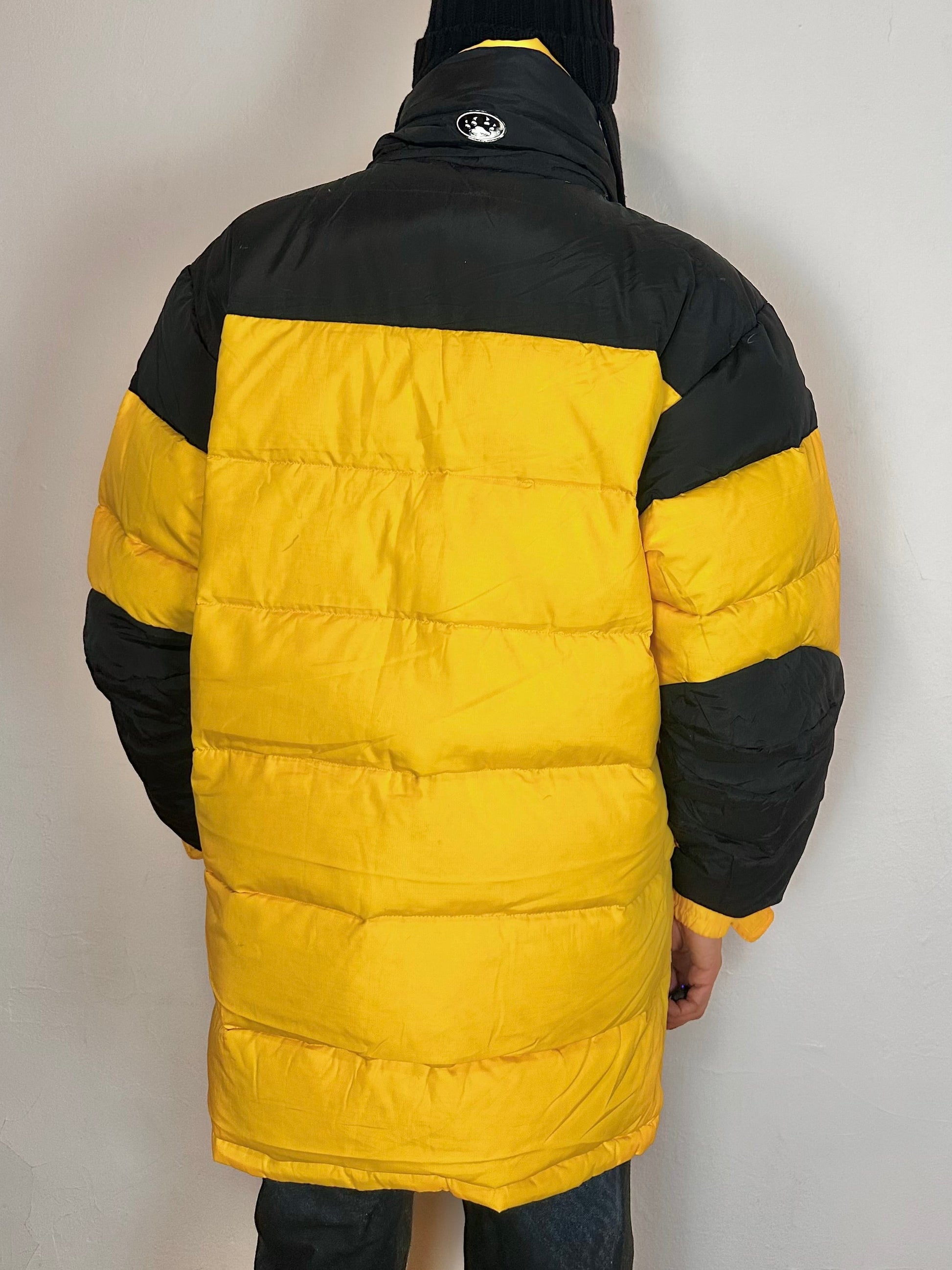 Back side of Bear Mountain yellow puffer jacket with oversized architectural fit, chest logo detail, super warm insulation, size XL.
