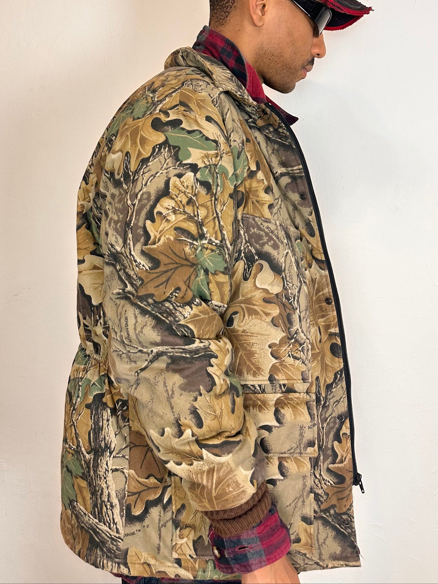 Right side on Vintage brown RealTree camouflage quilted jacket with insulated lining, knit cuffs, four front pockets, boxy fit, size XL.