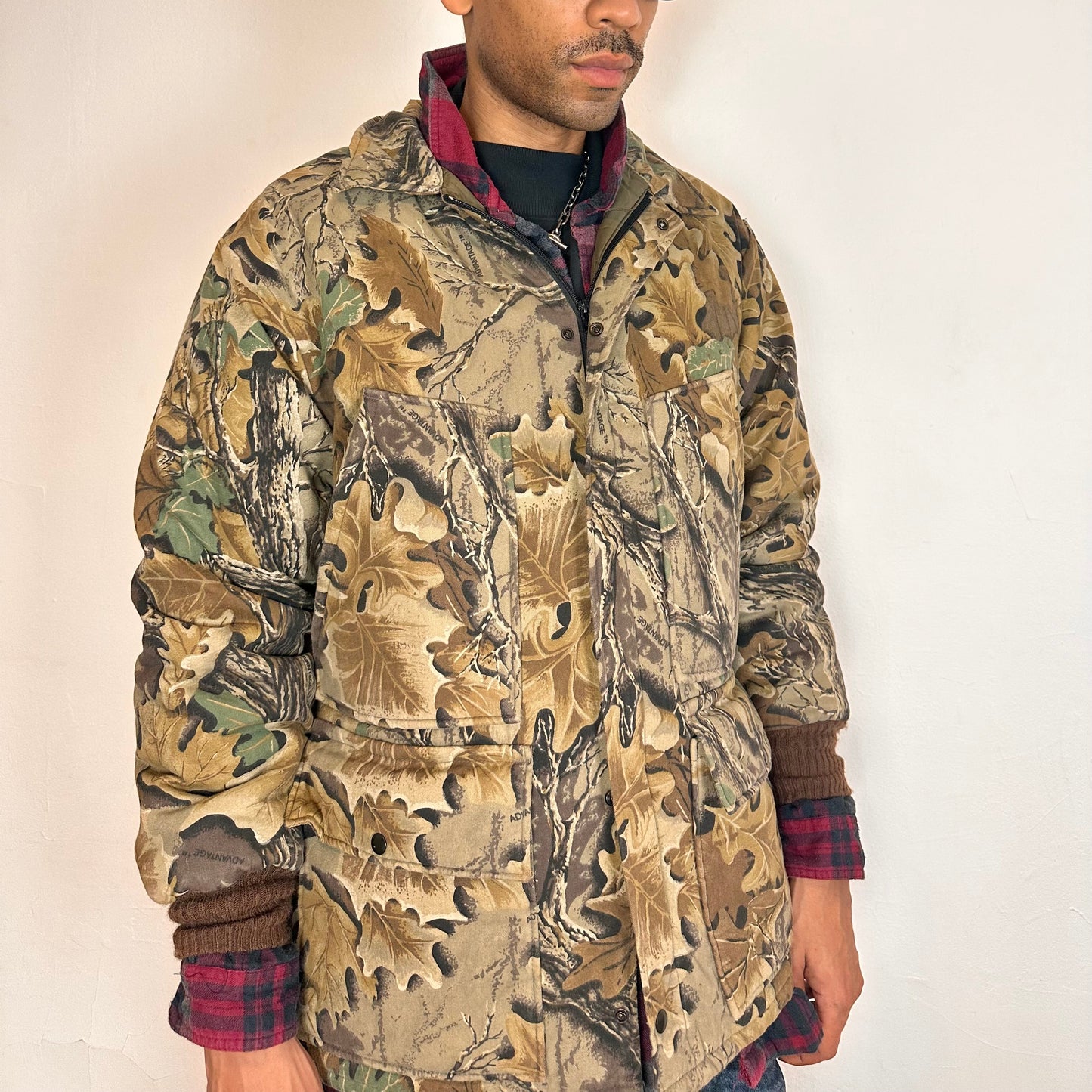 Front of Vintage brown RealTree camouflage quilted jacket with insulated lining, knit cuffs, four front pockets, boxy fit, size XL.