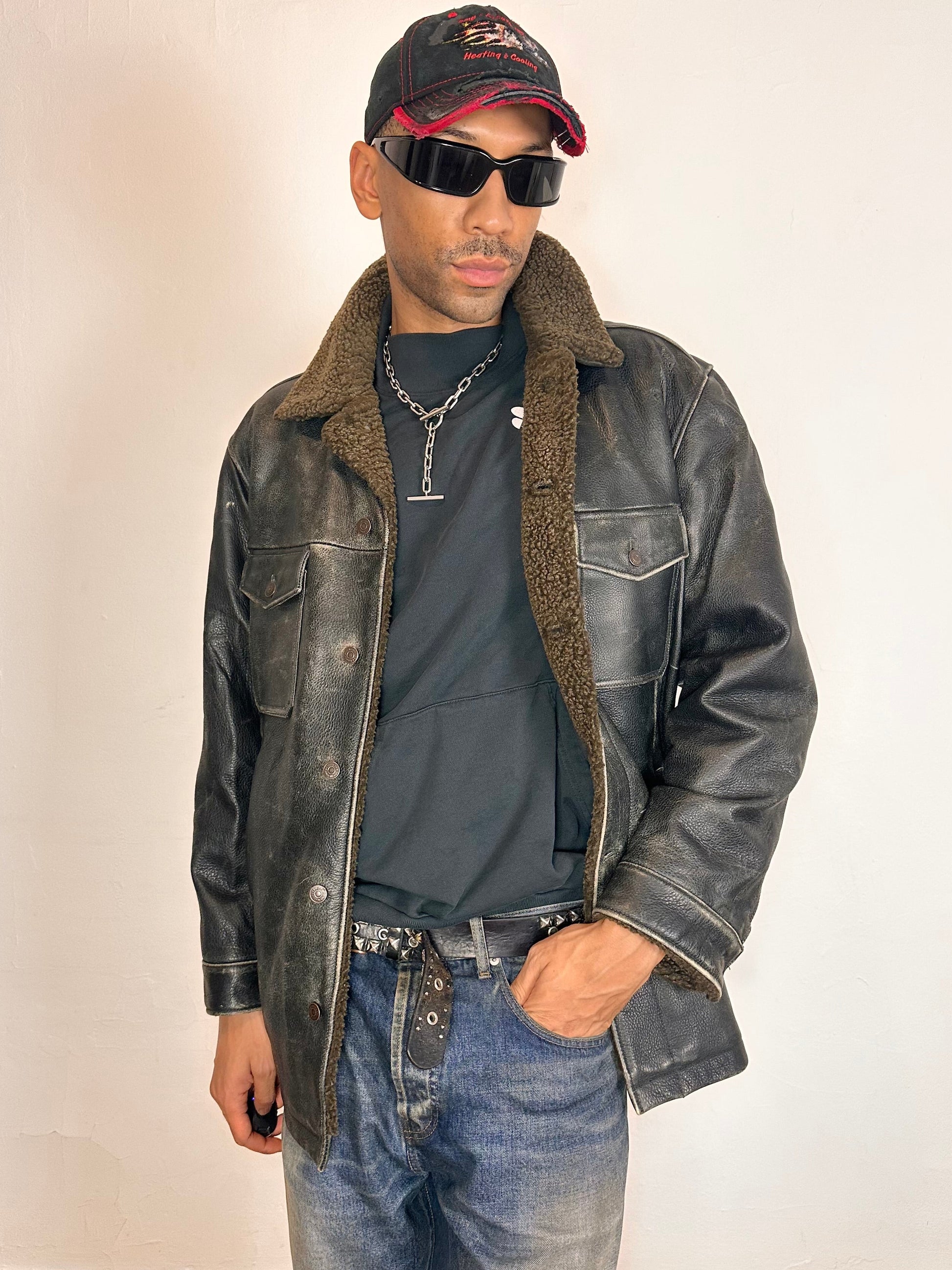 Styled image of Vintage GAP blackish-brown leather shearling jacket with sherpa collar and interior, chest and hip pockets, rugged fatigued finish, size XL.