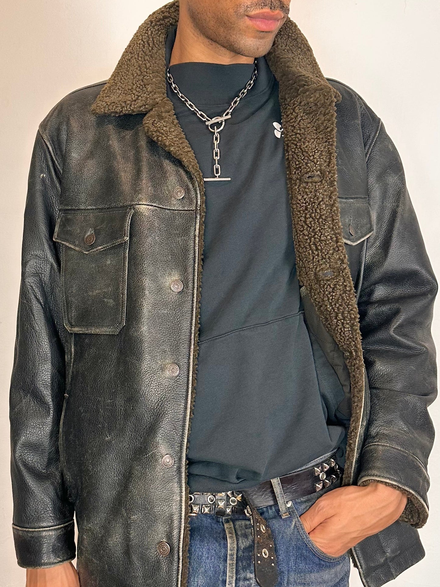Close up of Vintage GAP blackish-brown leather shearling jacket with sherpa collar and interior, chest and hip pockets, rugged fatigued finish, size XL.