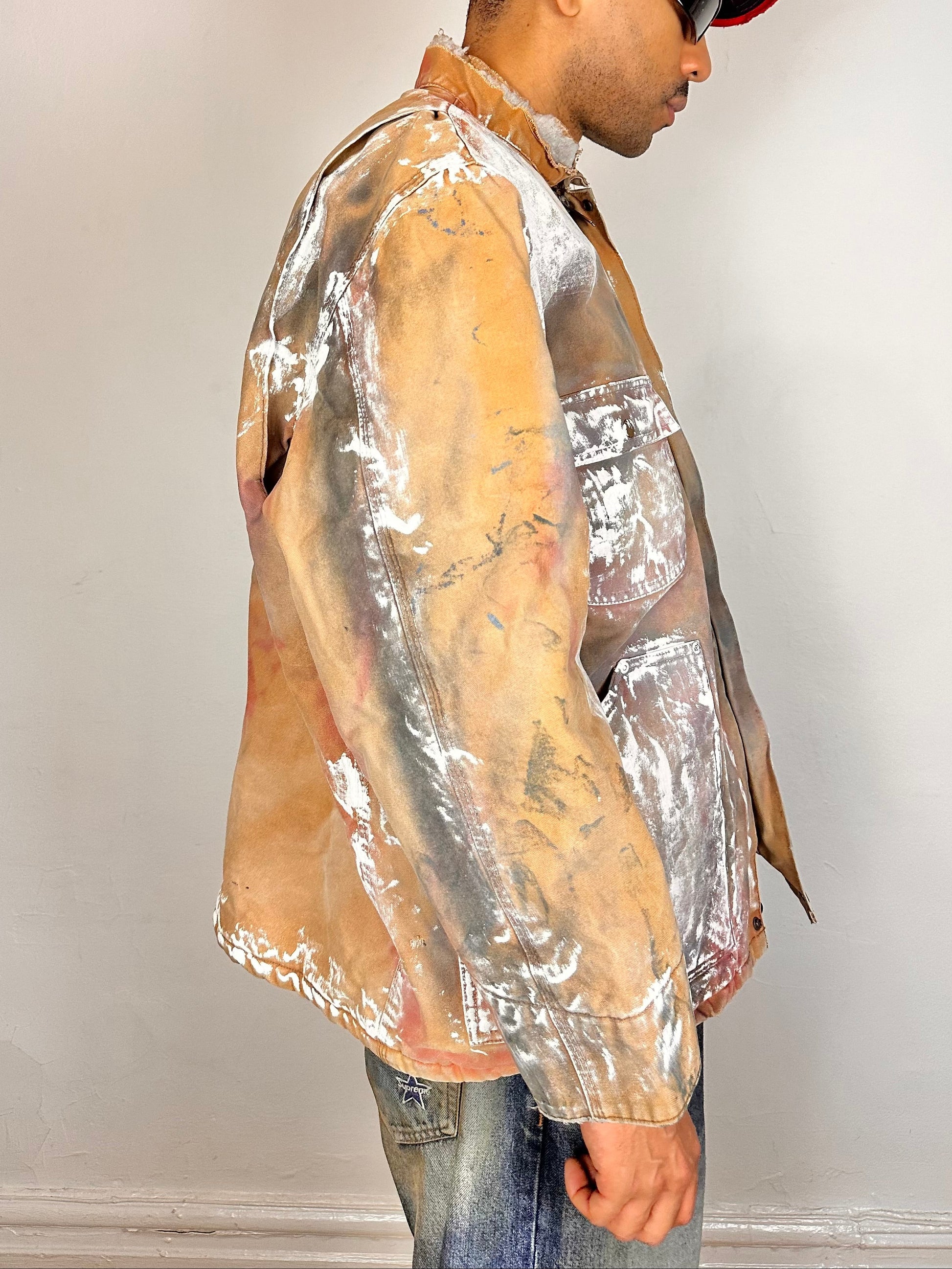 Right side on ASTROBOI* Big Smith tan workwear jacket with quilted lining, boxy fit, deconstructed collar, and black red white paint detailing, size XL.